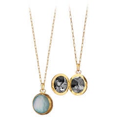 A Gold, Blue Topaz and Mother of Pearl Locket by Monica Rich Kosann