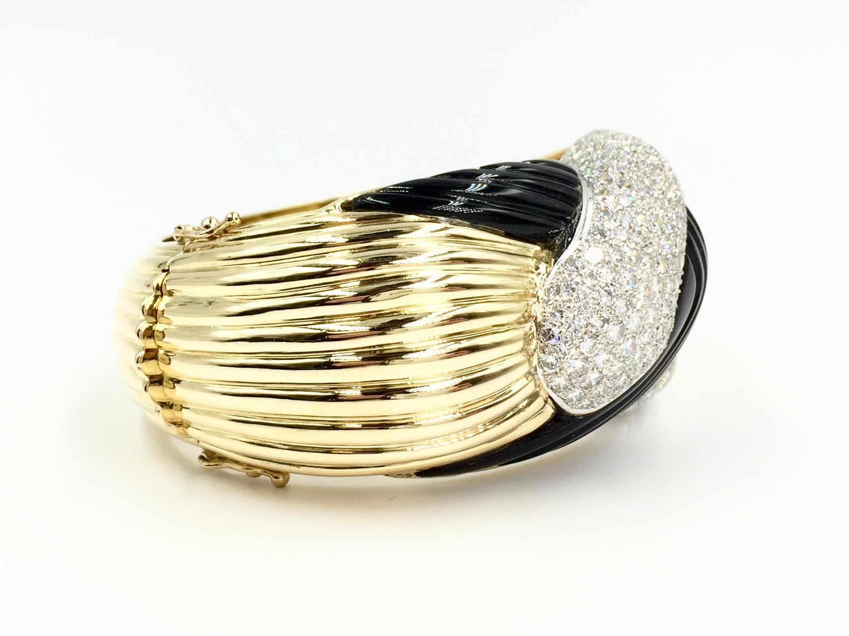 Circa 1986. This heavy and substantial 30mm wide 18 karat gold bangle bracelet features 186 round brilliant diamonds at 5.52 carats total weight. High quality diamonds have an approximate quality of E-F color, VS2 clarity are expertly pavé set in