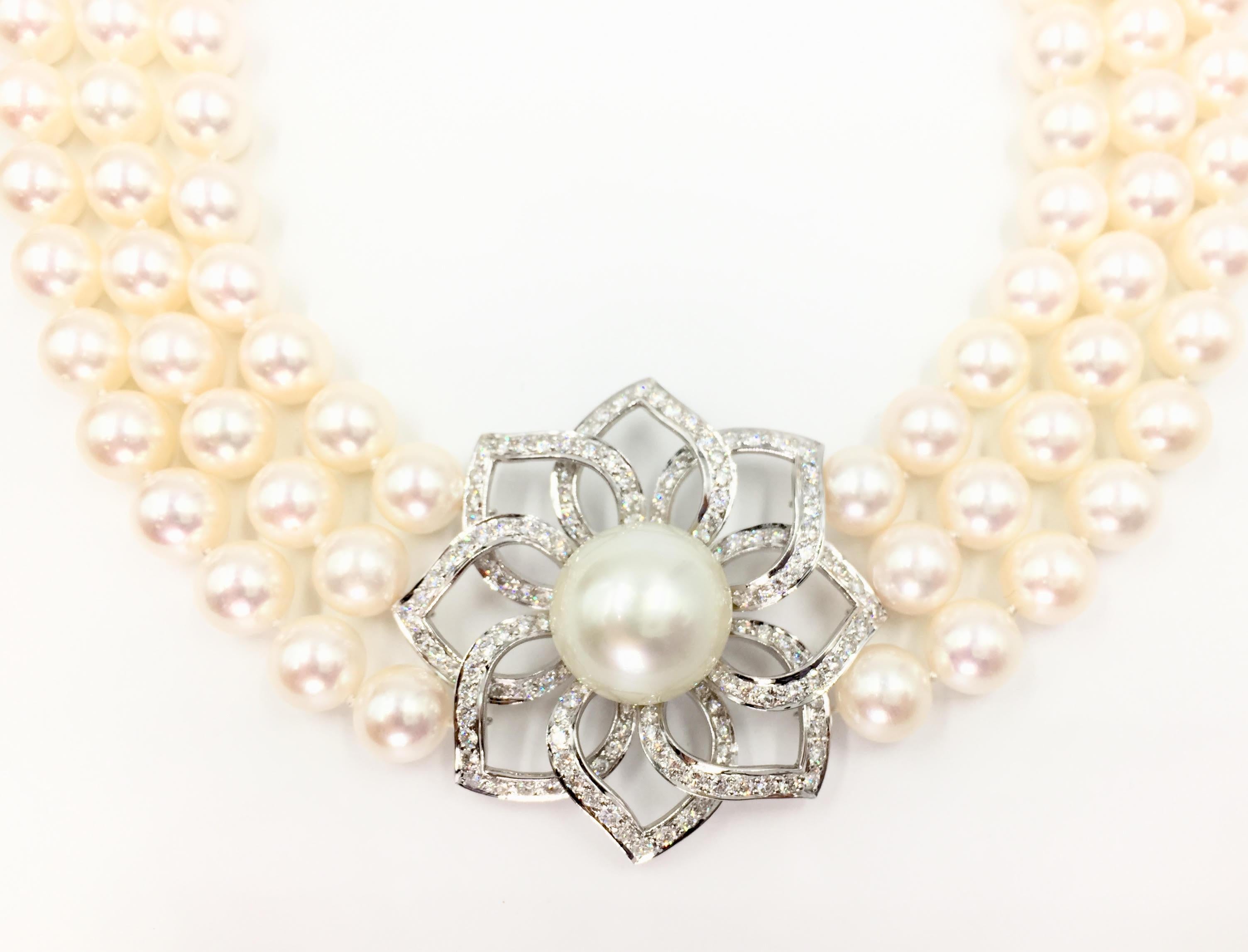 Gorgeous three strand Akoya cultured pearl necklace with stationary diamond and South Sea pearl flower center pendant. Necklace is composed of 122 beautifully matched, lustrous white 9mm cultured pearls. Open diamond flower center pendant measures