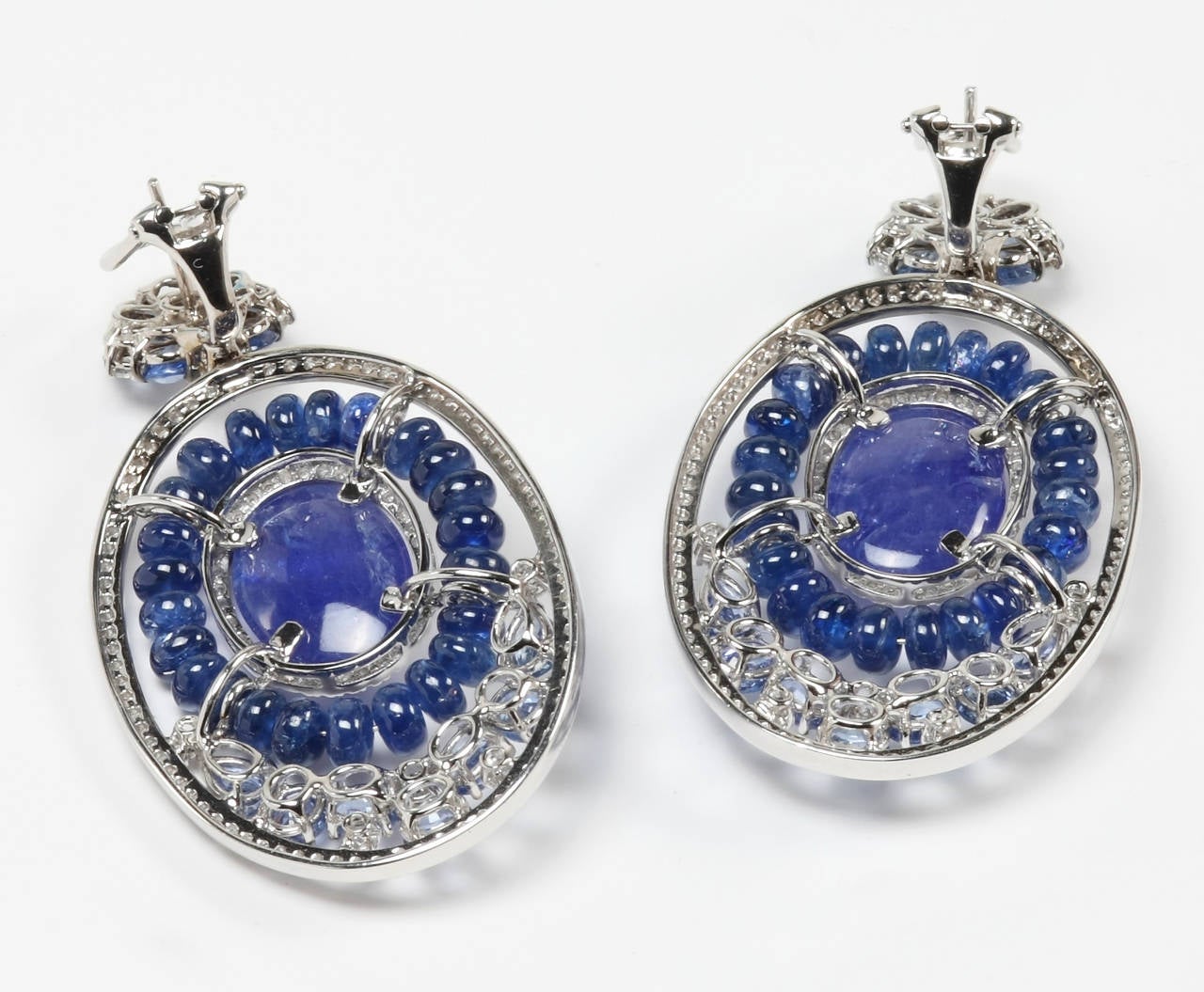 This bold and fabulous 18K earring is a real show-stopper with alluring blue hues of tanzanite gemstones and sapphires. Diamonds add to the elegant finish. Earrings are also fitted with omega back closures.
 
Tanzanite 58.50cts
Blue Sapphire