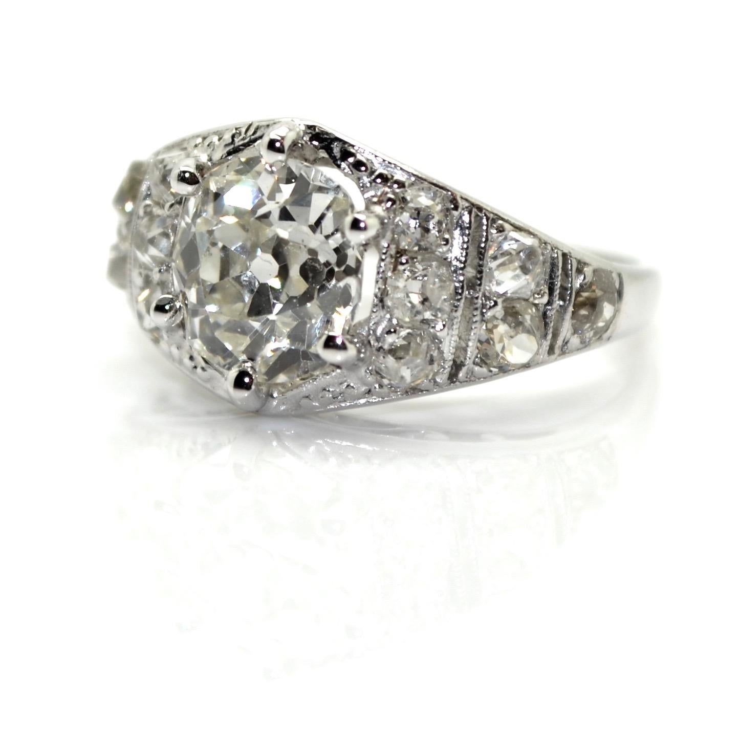 French Art-Deco platinum ring set with an old European cushion cut diamonds and graduating stepped shoulders, circa 1920.
The central diamond is weighting approximatively 2.10 carat (estimated H-I color and SI clarity). The total approximate diamond