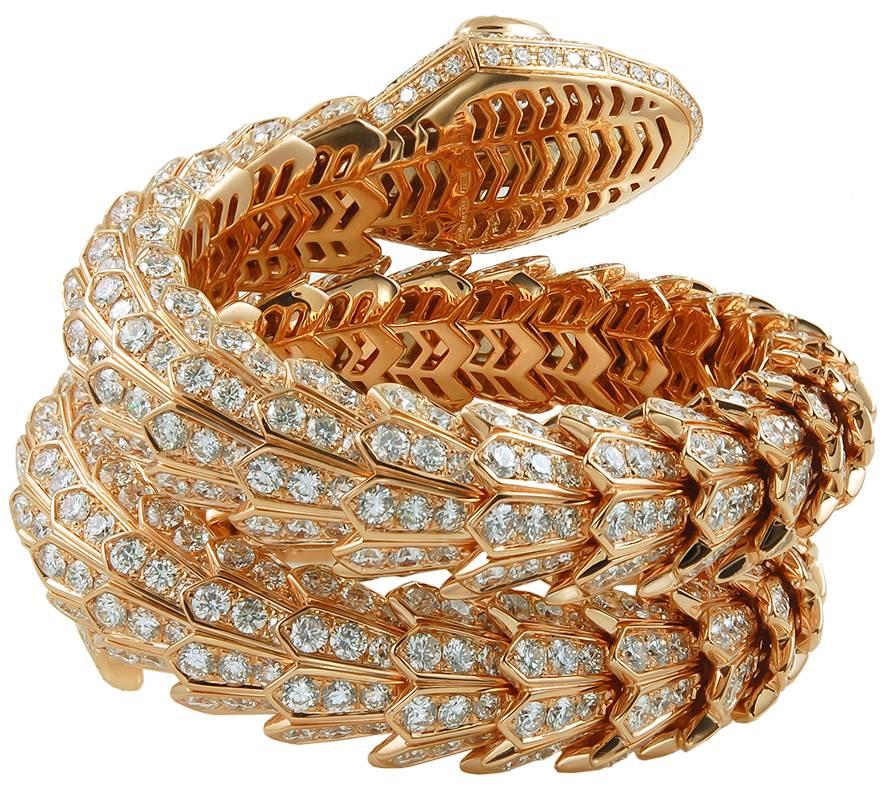 A twin-wrap Bulgari Serpenti diamond bracelet in 18k rose gold, designed with a  sprung mechanism of jagged, overlapping scales; each with four sections of brilliant-cut diamonds, and culminating in the rounded head set with two pear-shaped diamond