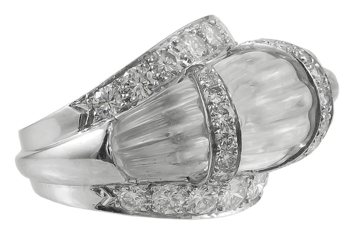 DAVID WEBB Rock Crystal Fluted Bombe Ring in Platinum.

A juicy bubble of fluted rock crystal with rows of inset round brilliant diamonds set in platinum. The inside of the ring is hollow in form along with a metal shank for durability in this