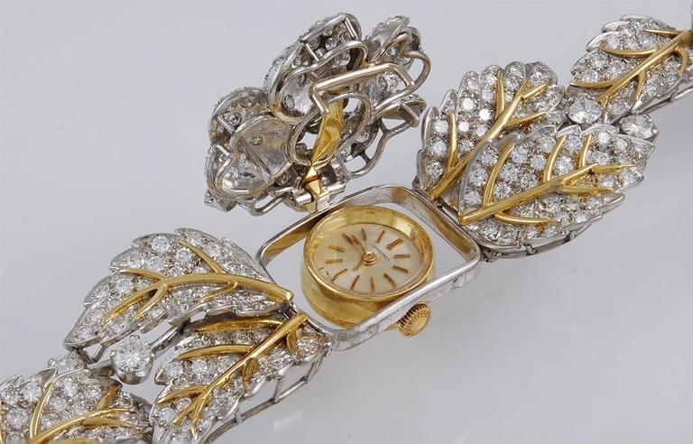 LONGINES Diamond Garland Convertible Watch Bracelet in 18k Yellow Gold and Platinum.

A vintage Longines watch embedded in a dimensional garland of gold and diamonds, dating from the 1980s. This convertible watch includes a hidden clasp and hinge