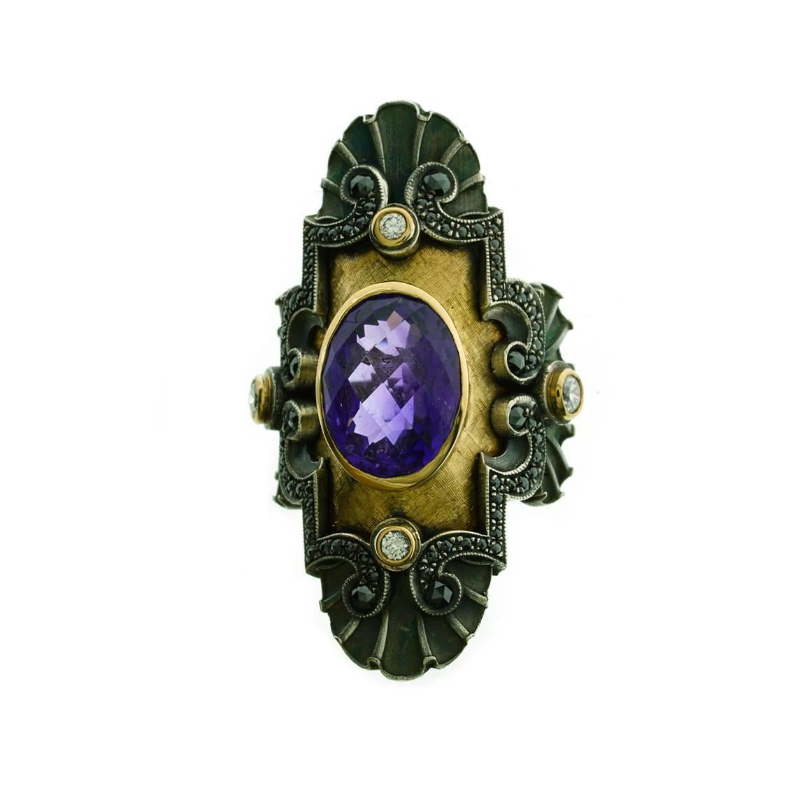 This majestic ring has been designed with a monumental Medieval profile with stunning Art Deco Style flourishes.

Handmade in 18kt yellow gold and oxidized sterling silver. This glorious ring features a central oval, checkerboard cut amethyst,
