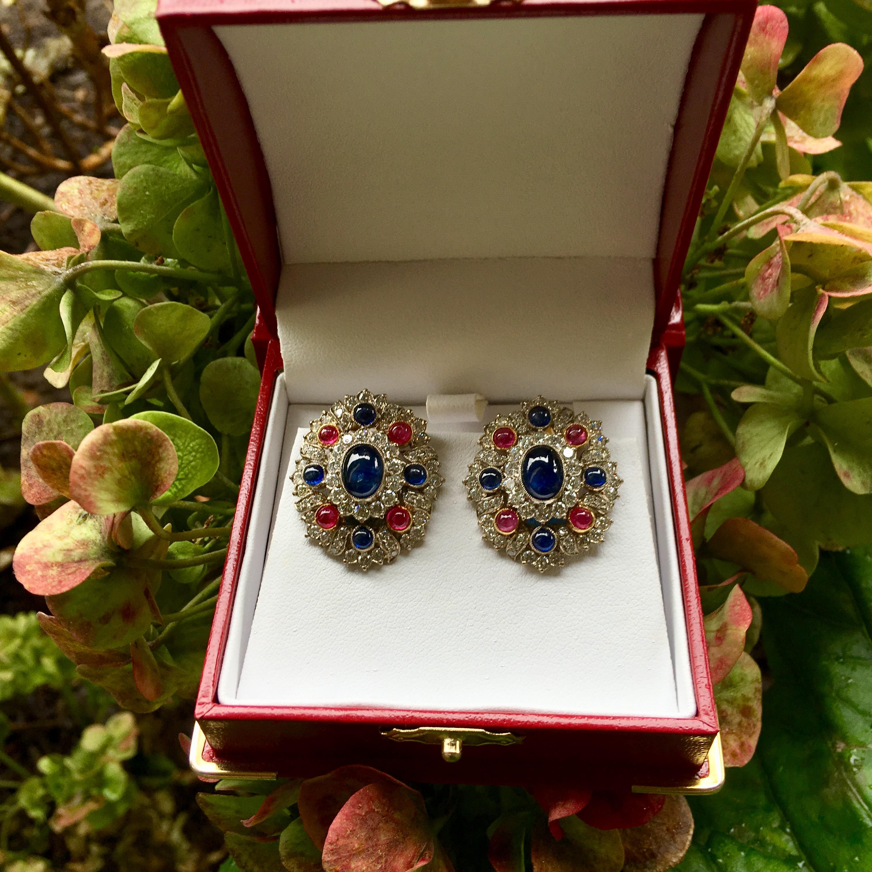Very elegant, red round cabochon ruby, oval blue sapphire, round blue sapphire, and white diamond earrings feature retractable posts, suitable for both pierced and non-pierced ears.  Posts are hinged and may be folded down to become clip-on earrings