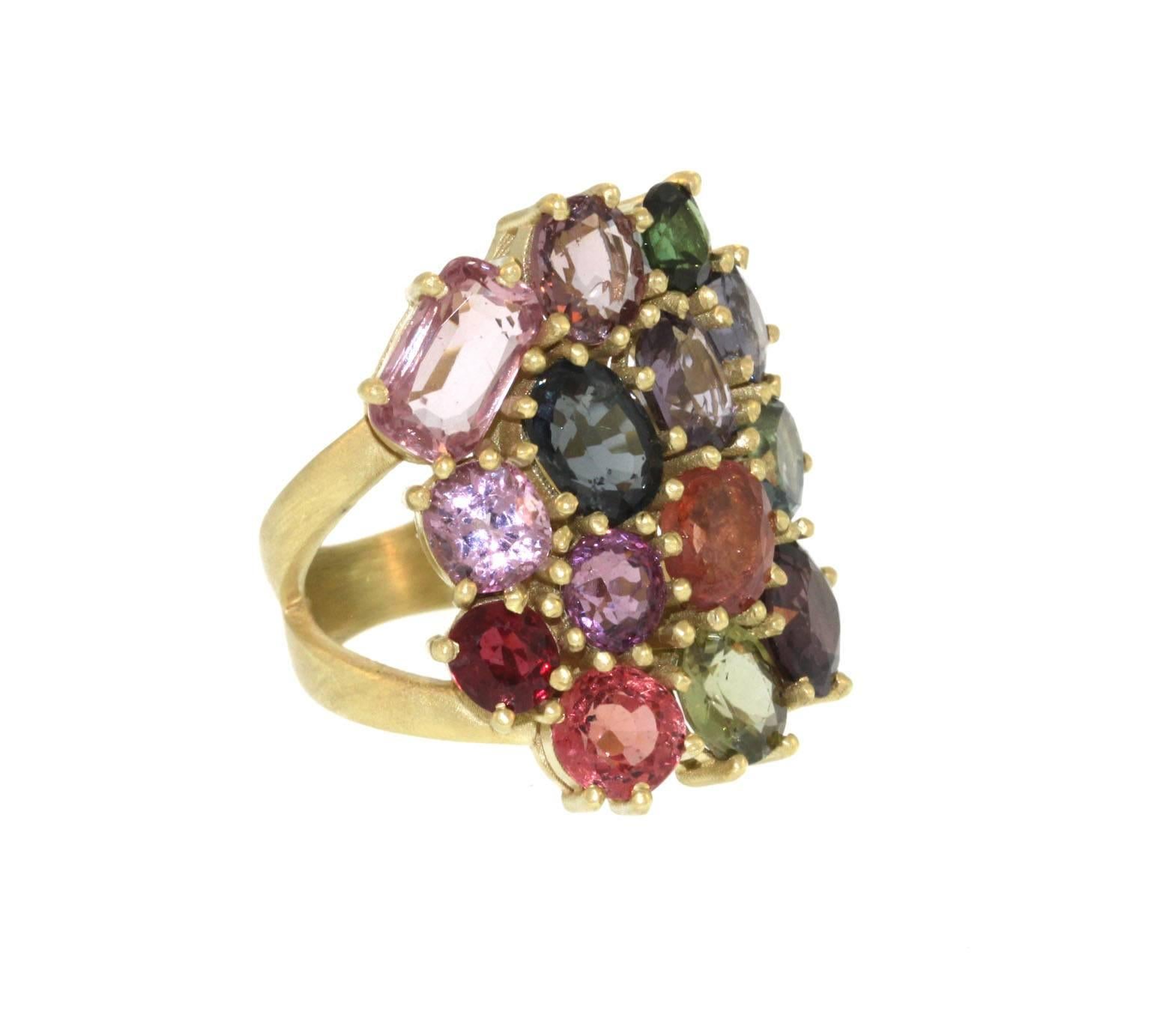 The perfect ring for a Garden party, this playful and colorful cluster ring is an attention getter! Fourteen spinel stones of varying shapes and sizes are prong set in a cluster pattern. Two V-shaped 3mm bands on each side of the cluster taper to