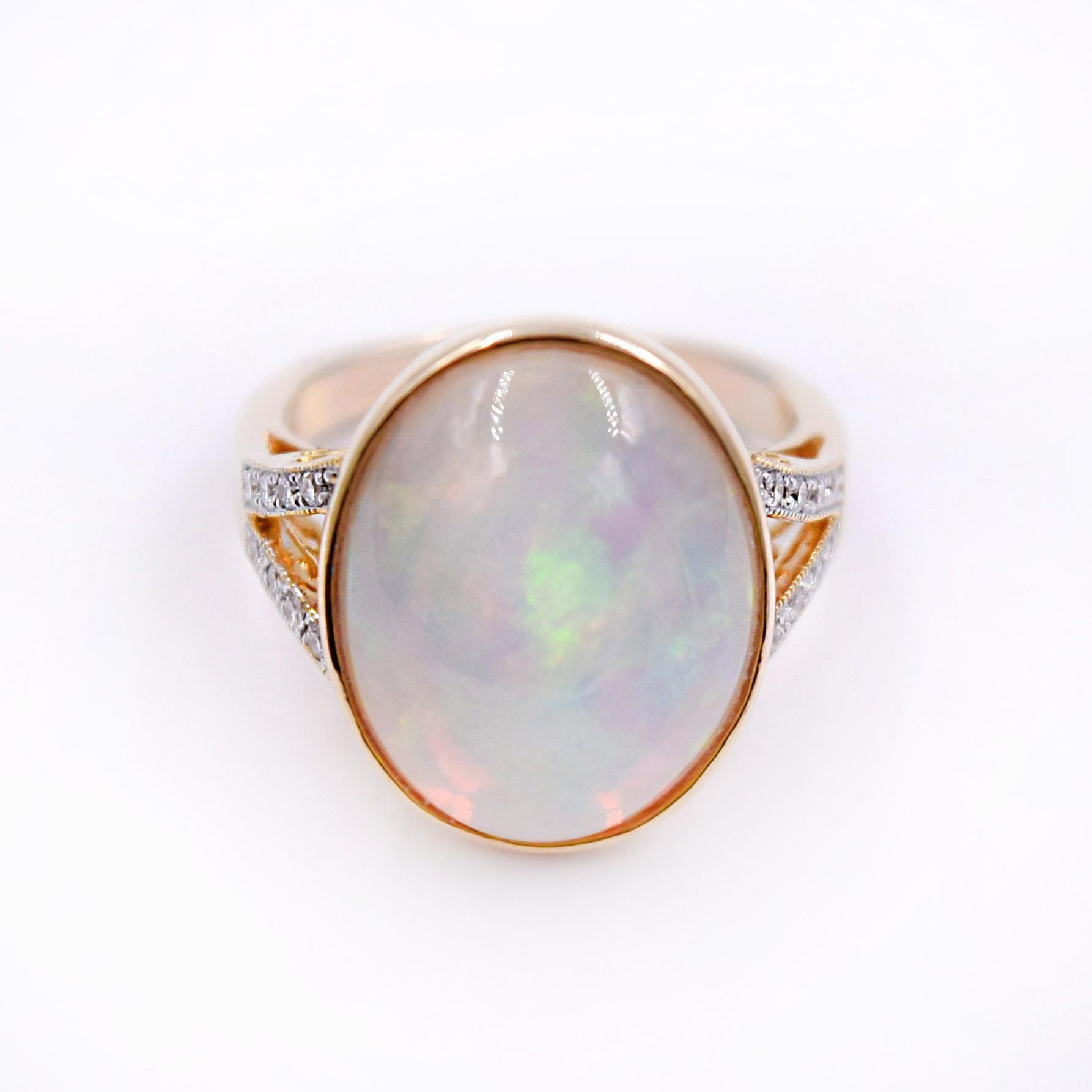 8.09 Carat Ethiopian Opal and 0.18 Carat White Diamonds are set in  14 Karat Yellow Gold.
The size of the ring is 7.5 and can be sized.