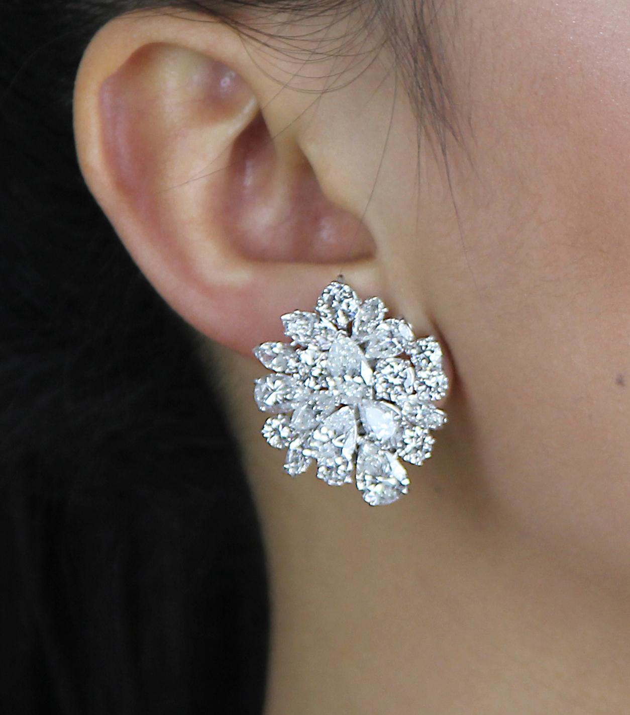 Bespoke stunning earrings set with various shapes and sizes of diamonds, all carefully clustered together to create a masterpiece. Set with pear, marquise and round shape brilliant cut diamonds set in platinum and 18 ct white gold. Clip-on fittings