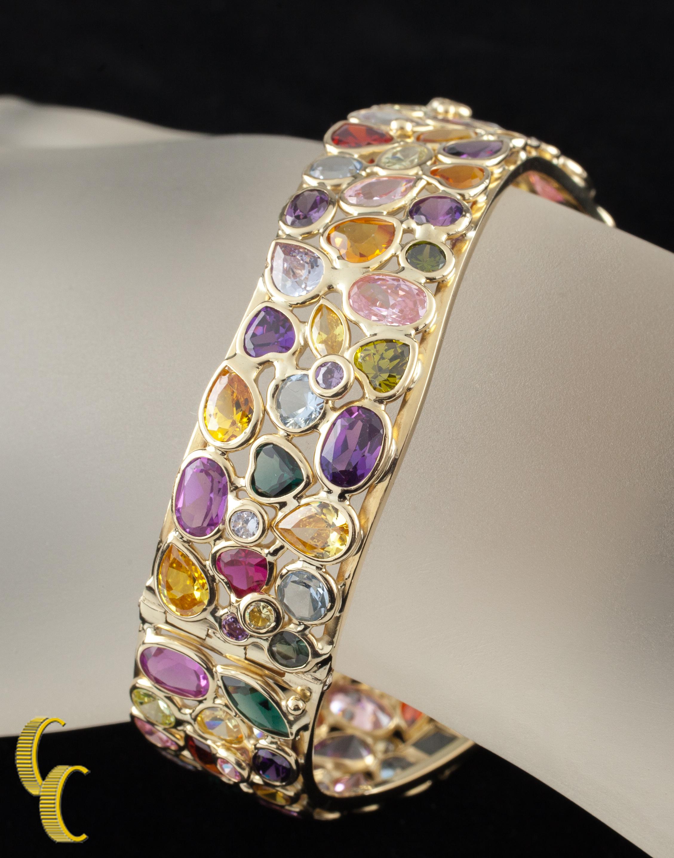 Features Custom Bezel Settings for Each Stone
Various Colored Gemstones in Marquise, Round, Heart, Oval, and Square Cut Varieties
Bangle Features Slight Wave Design
Approximate Width of Bangle = 17 mm
Inner Circumference (Wrist Fit) = Approximately