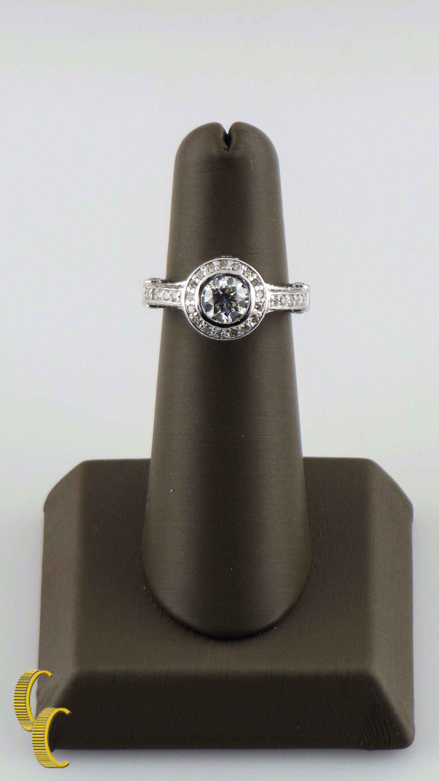 Features Round Brilliant Center Stone w/ Elaborate Gallery Crusted w/ Pave-Set Round Brilliant Accent Stones
Round Brilliant Center Diamond
Approximately= 1.00 carats
Clarity Approximately= SI-1
Color Approximately= I
Round Brilliant Accents