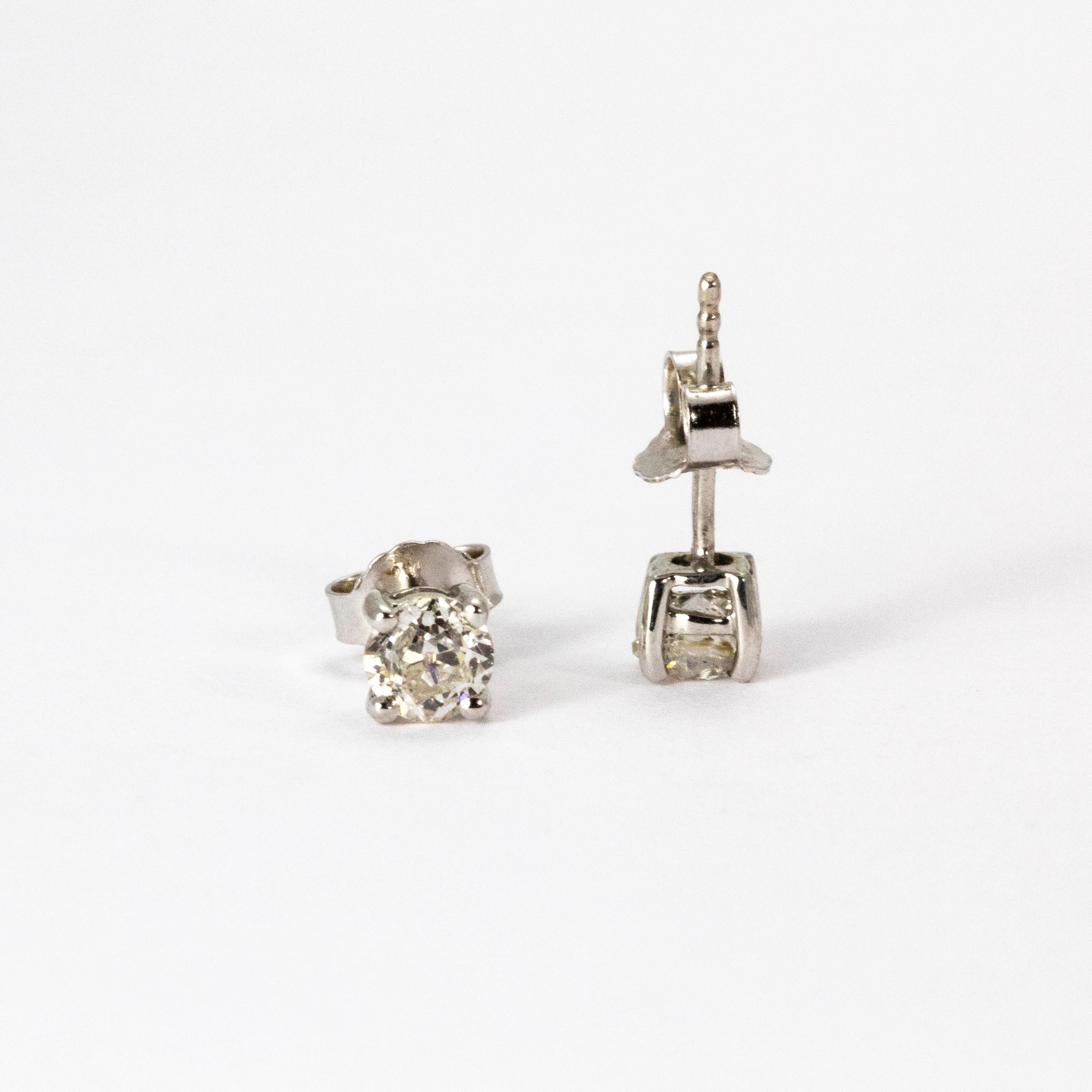 A pretty pair of Art Deco diamond stud earrings. Each earring hosts a brilliant white old European 35 point diamond, I colour and clarity SI2, in a classic four-claw setting. Modelled in 18 karat white gold.