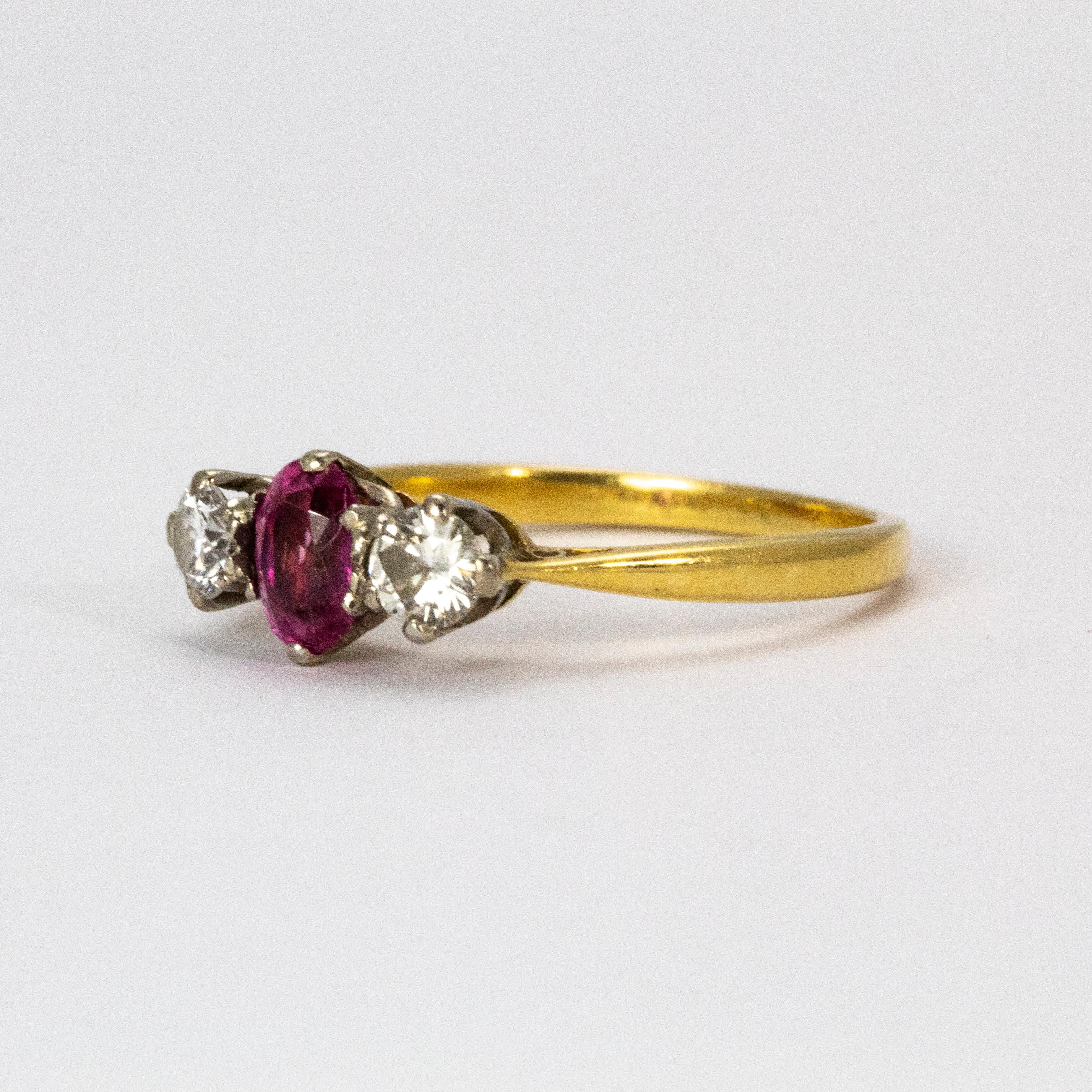 A gorgeous vintage three-stone ring. The wonderful central ruby weights 30 points, and on either flank sits a bright white diamond each weighing 25 points. Modelled in 18 Karat yellow gold, with platinum claw settings around each stone.

Ring Size: