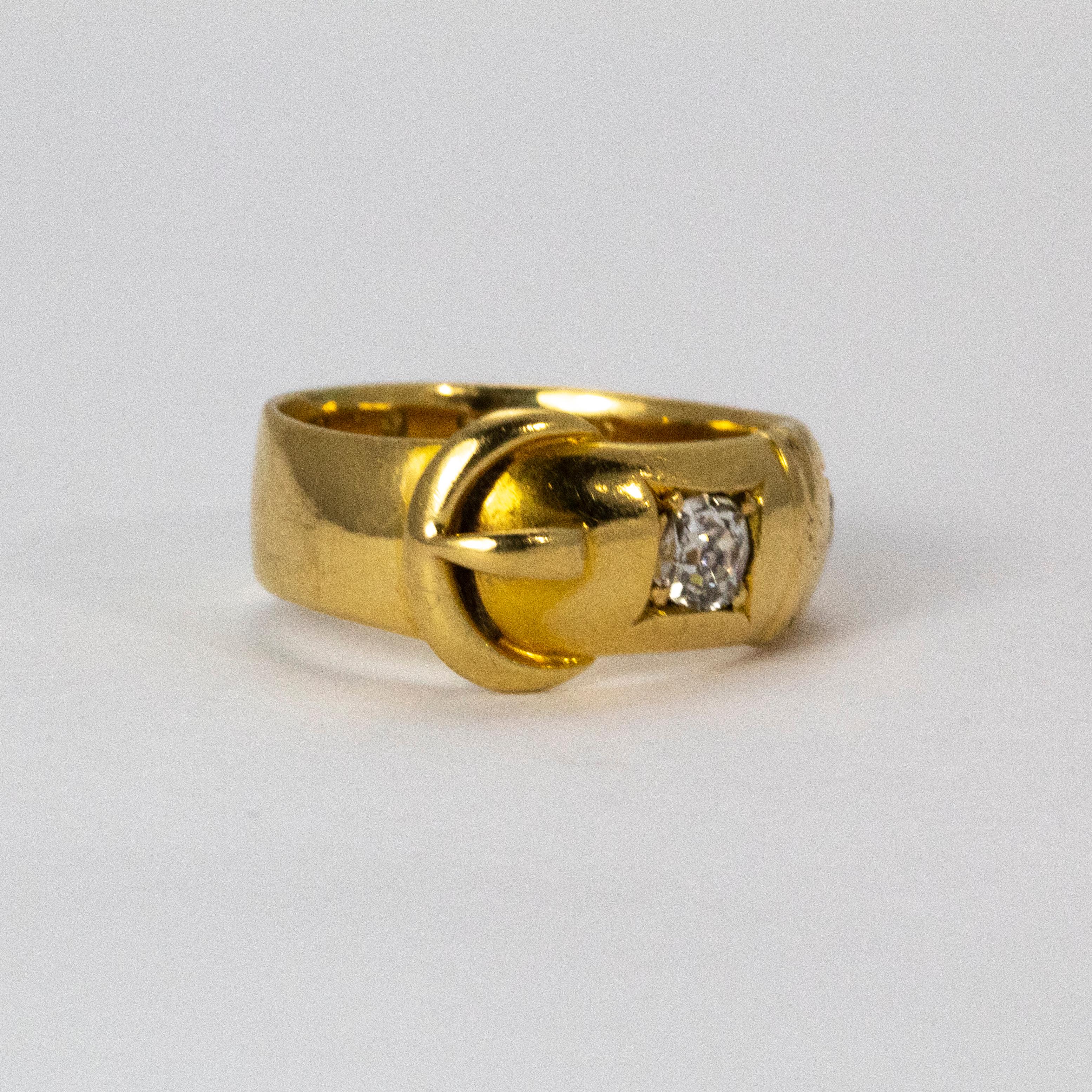 A beautiful Victorian 18 karat yellow gold diamond ring with buckle motif. The buckle became a popular symbol for jewellery in the 19th century; used to represent strength, loyalty, love, and protection to a loved one. The two brilliant old European