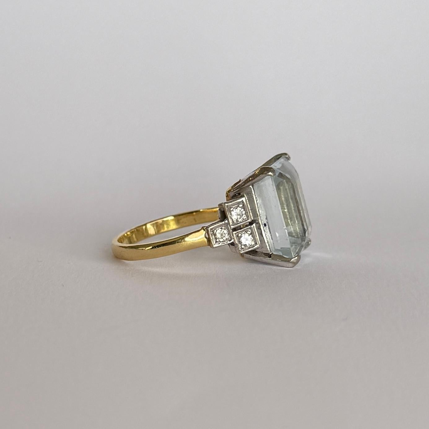 Striking blue topaz set simply in platinum and the ring is modelled in 18carat yellow gold. The diamond total of the shoulders is 30pts. 

Ring Size: O or 7 1/4
Topaz Dimensions: 8.5x11mm
Height Off Finger: 10mm

Weight: 6.7g