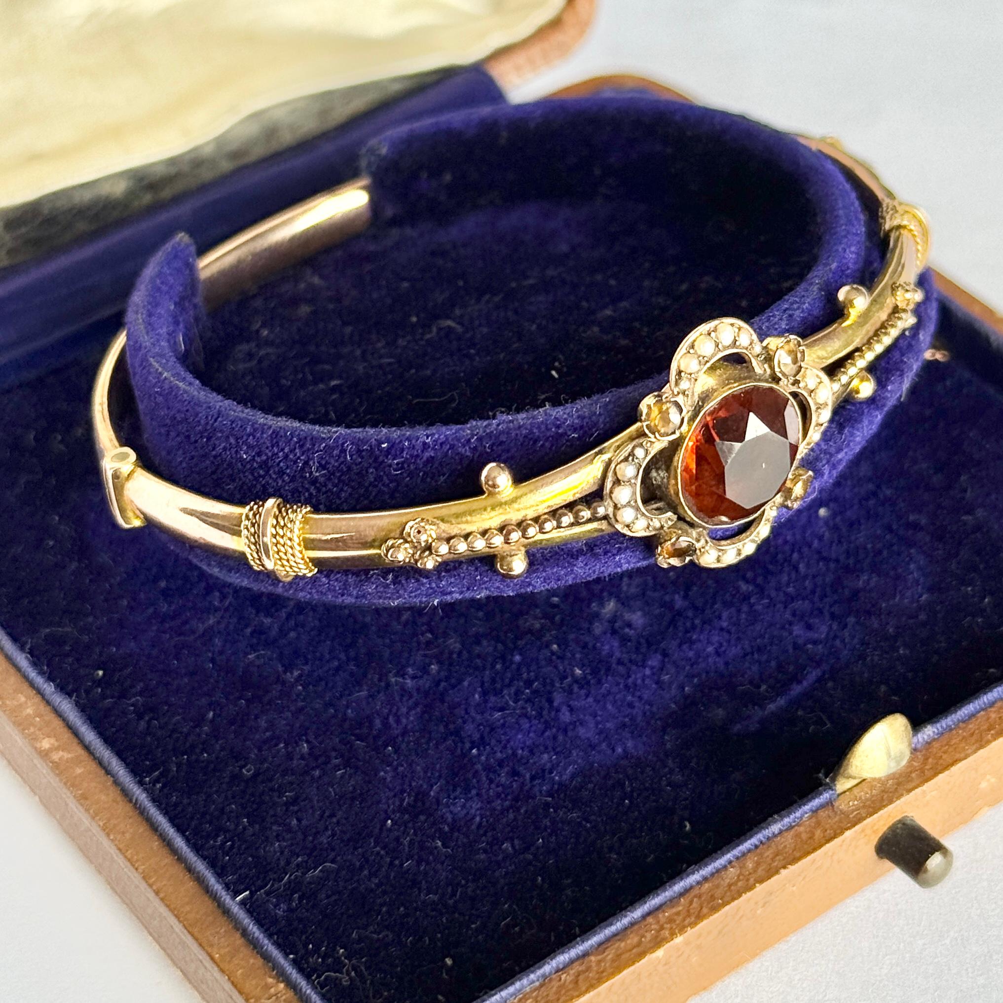 The detailed bangle holds Citrine stones and pearls. The detail on this bangle is stunning and so intricate. The central citrine measures approx 3.5carat and the four surrounding it measure 7pts each. Comes in antique bangle box.

Inner Diameter