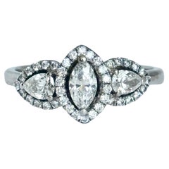 Modern Platinum Marquise and Pear Shape Diamond Three Stone Ring