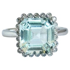 Bague solitaire en or blanc 18 carats sertie d'une aigue-marine certifiée et d'un diamant