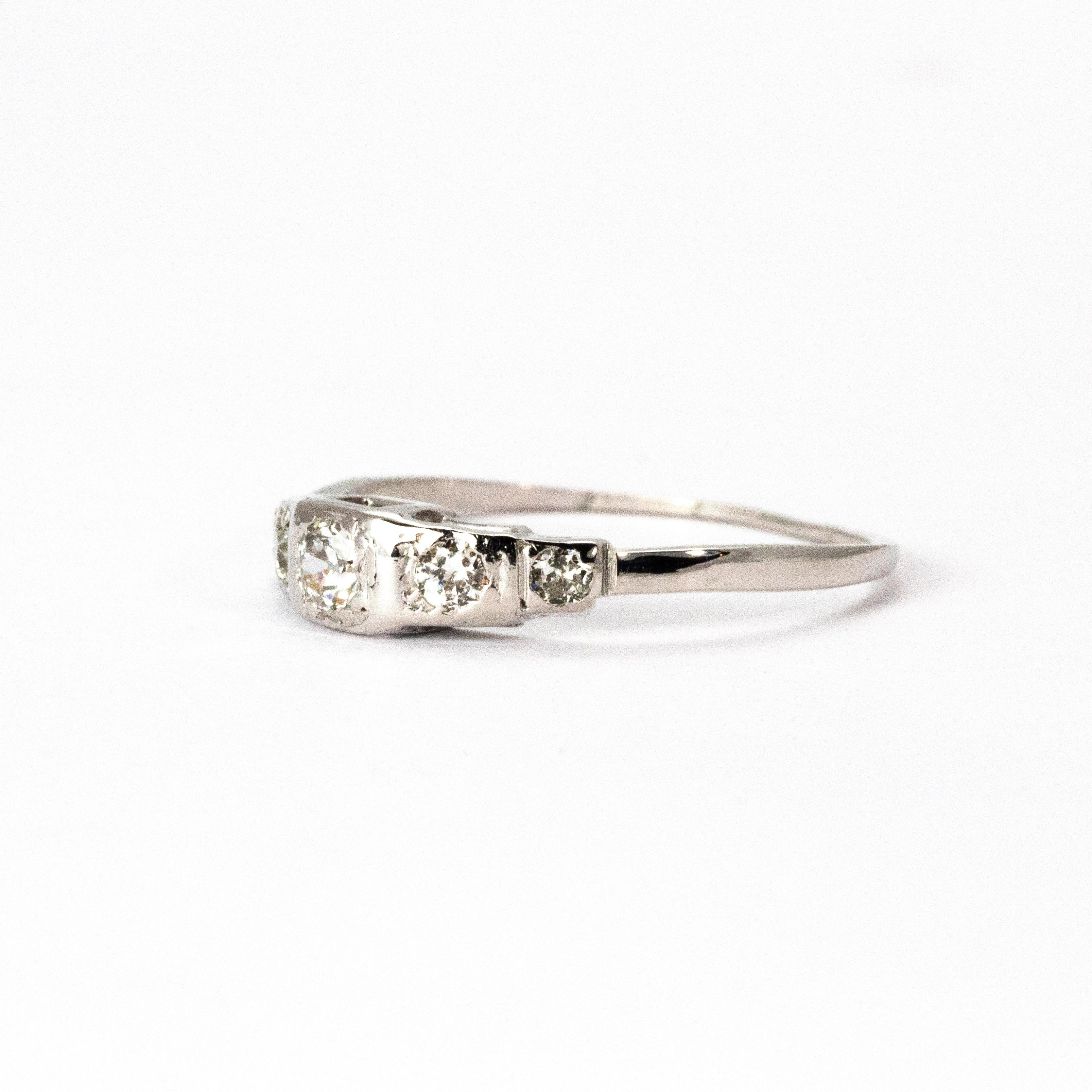 An elegant Edwardian diamond ring modelled in 18 karat white gold. The ring hosts a central diamond weighing 20 points and tapering diamond shoulders, I colour and VS2 clarity.

Ring Size: O or 7