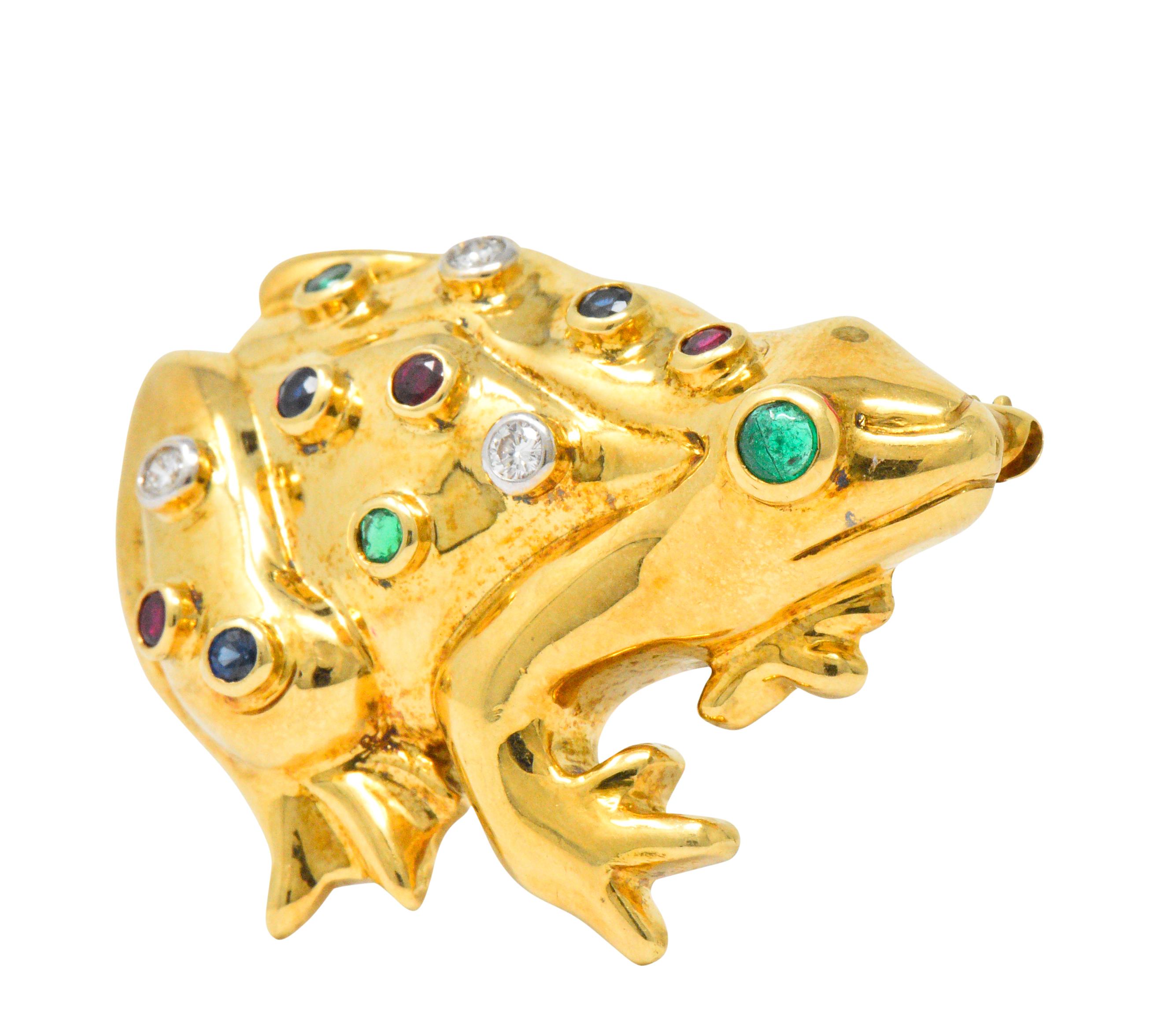 Featuring a high polished gold frog set with emeralds, rubies, sapphires and diamonds - all bezel set

Three round brilliant cut diamonds, G/H color, VS clarity

Three round cut rubies, deep bright red

Three round cut sapphires, deep bright