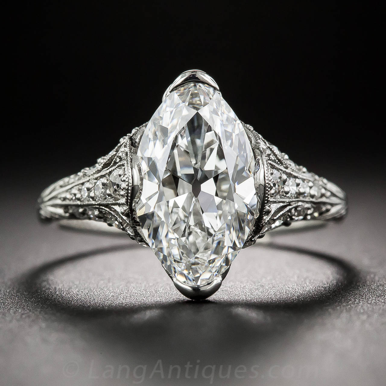 The pièce de résistance. From the first or second decade of the last century, a remarkable and resplendent gem by America's premier jeweler - Tiffany & Company. An icy-white, full-figured, old European-cut marquise diamond, with softly rounded tips