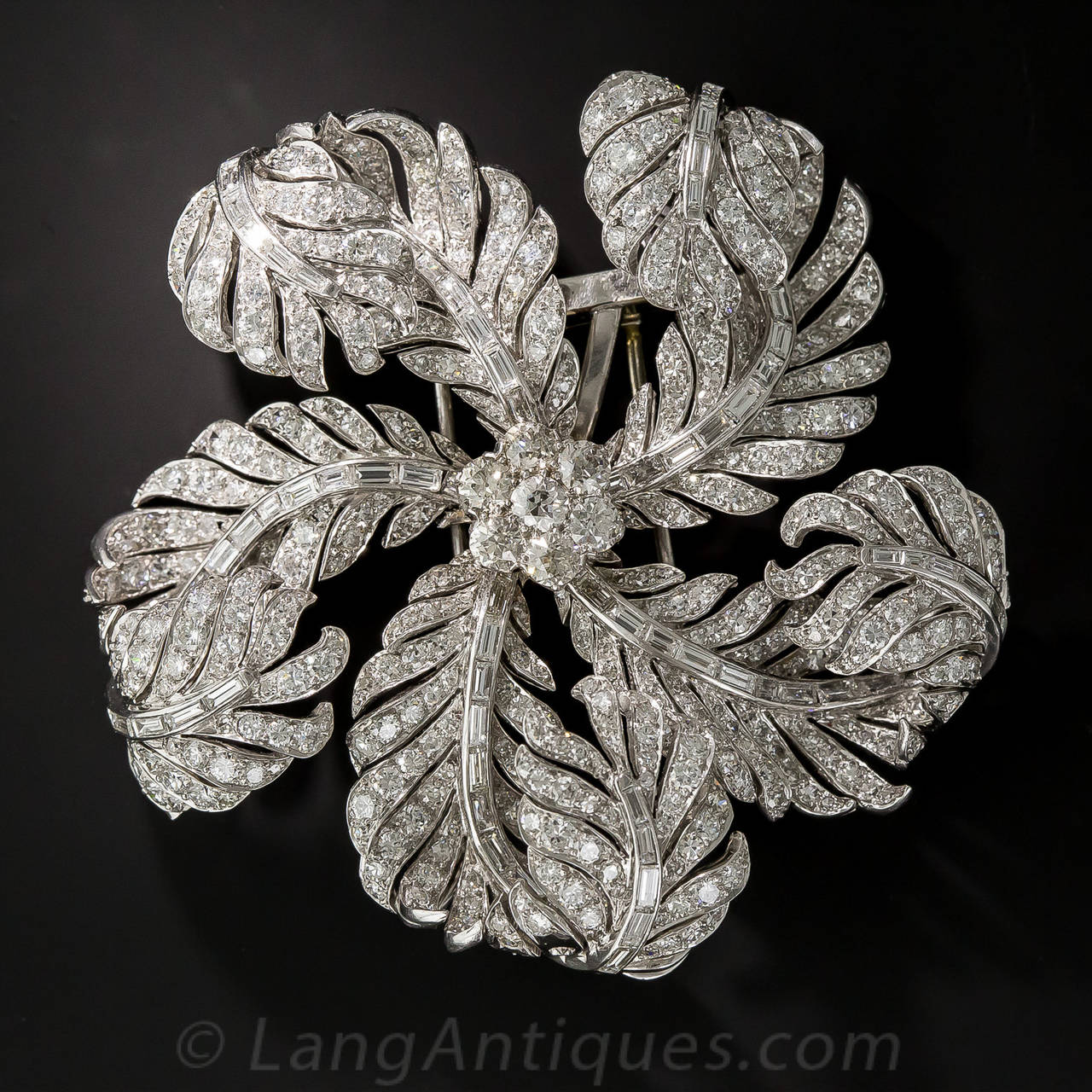 A sparkling pinwheel comprised of blinding bright-white diamond feathers makes for the most magnificent and mesmerizing corsage brooch ever! Measuring an impressive 2 and 5/8 inches, this opulent, multi-dimensional ornament contains 20 carts of