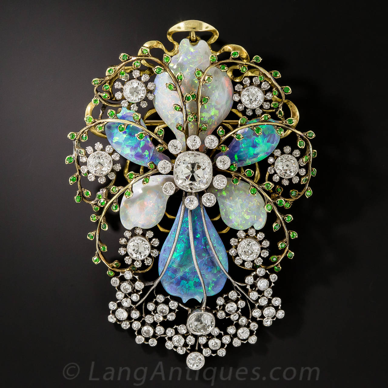 Amazing is the adjective that comes to mind when describing this masterpiece from the turn of the 20th century. Art Nouveau artistry is in full flower in this stunning jewel composed of black opals, white opals, diamonds and rare demantoid garnets.