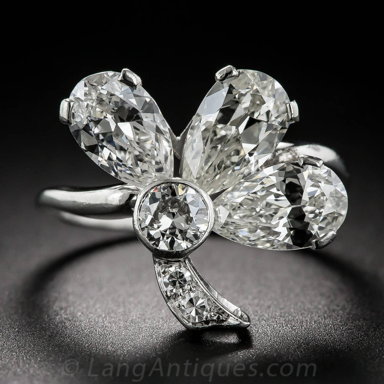 A tantalizing trio of bright-white, pear-shaped diamonds, totaling 3.00 carats, produces a powerful punch, not to mention the luck of the Irish, in this truly gorgeous three-leaf clover ring, handcrafted in platinum - circa 1930. The resplendent