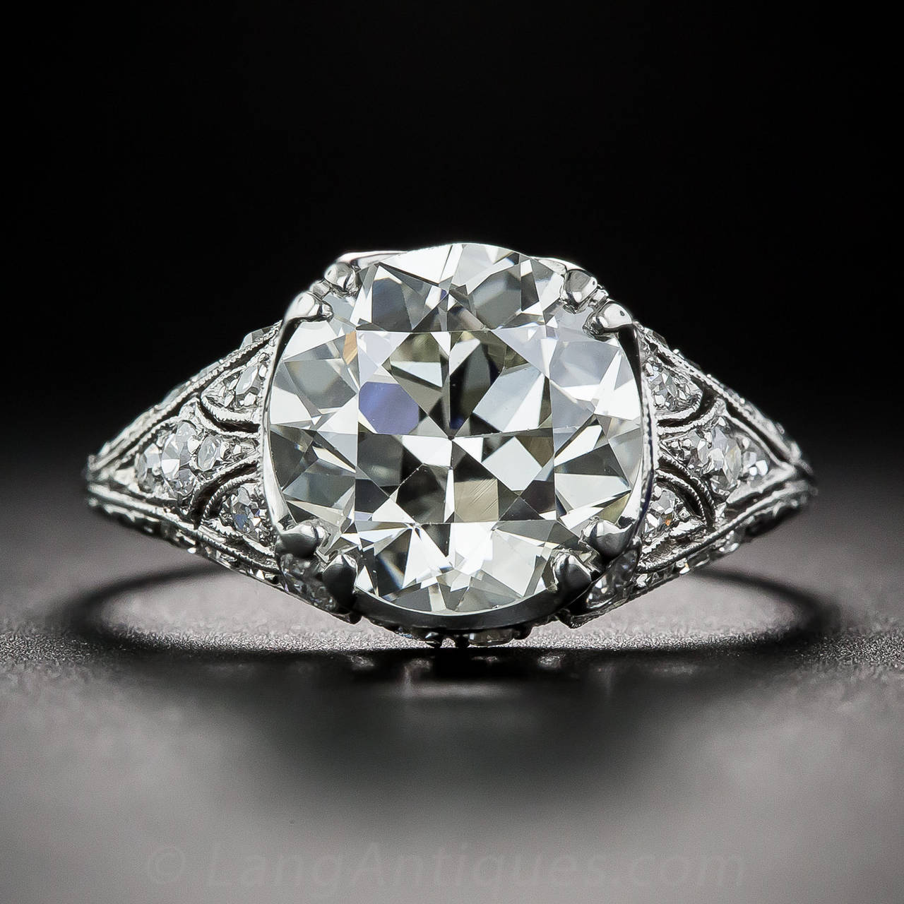 A big, bright and beautiful, high-voltage sparkler, weighing 3.10 carats, graded L color - VS1 clarity by our in house gemological laboratory, is the crowning glory of this rare, original Art Deco engagement ring. The resplendent, transitional