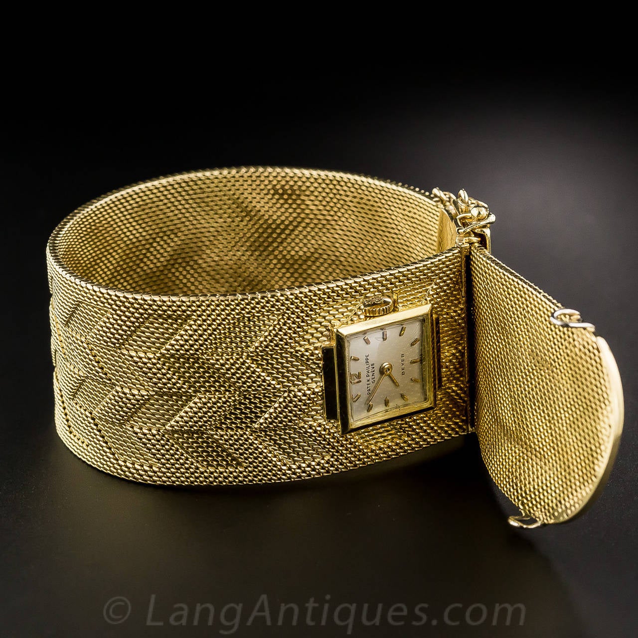 There's a hidden surprise waiting for you in this lavish 1 inch + wide 18K gold bracelet - a timepiece by none other than the world's most celebrated watchmaker - Patek Phillipe of Geneva, Switzerland. The weighty, yet lithe and supple, mesh