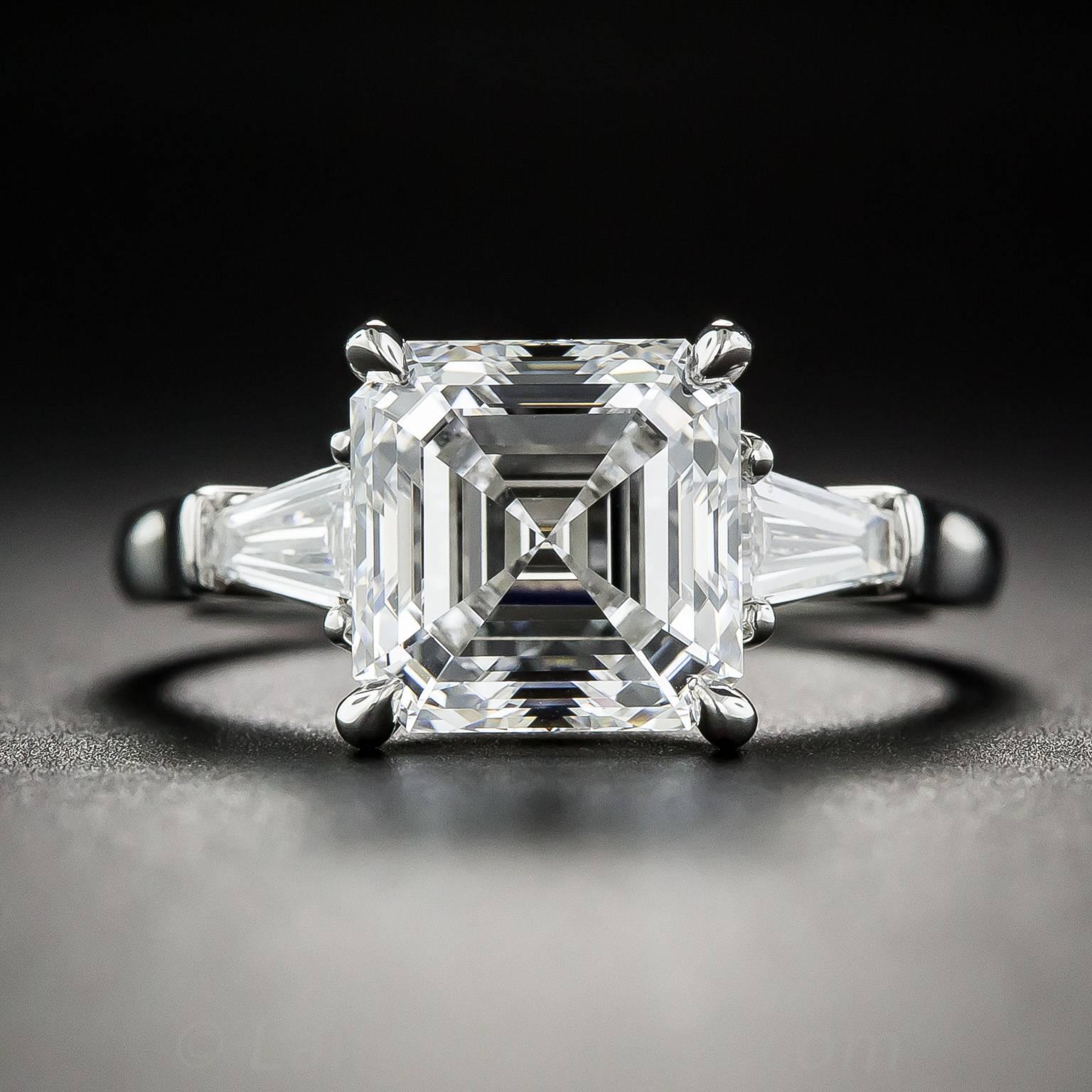 Impressive in both quality and scale, this hand fabricated platinum engagement ring features an ice-white square emerald-cut (aka Asscher-cut) diamond, accompanied with a GIA grading report indicating E color and VS2 clarity. The spectacular diamond