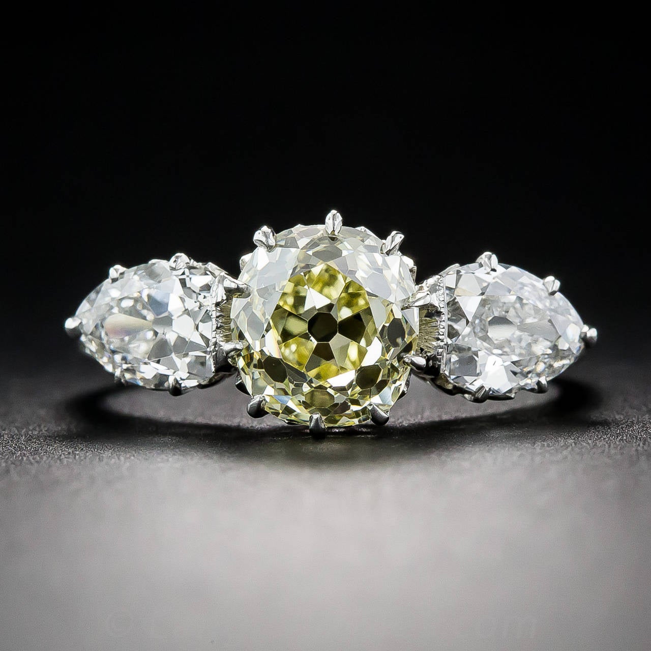 The central focus of this rare, ravishing and radiant Edwardian treasure, circa 1915, is a 1.81 carat antique cushion-cut diamond, graded Fancy Intense Yellow - VS1 clarity by the GIA Gemological Trade Laboratory. The beautiful natural colored
