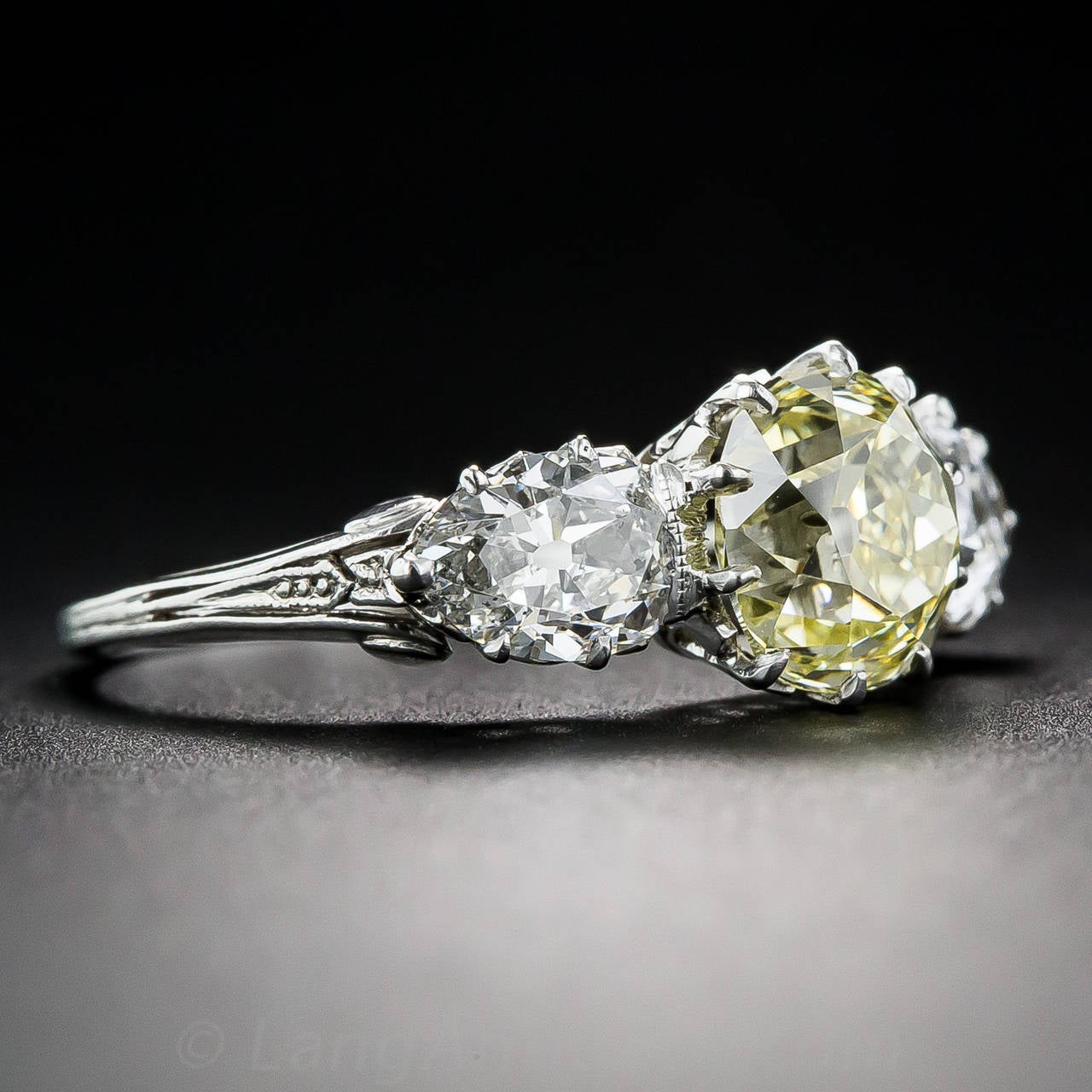 Edwardian 1.81 Carat Fancy Intense Yellow Diamond Platinum Three Stone Ring In Excellent Condition In San Francisco, CA