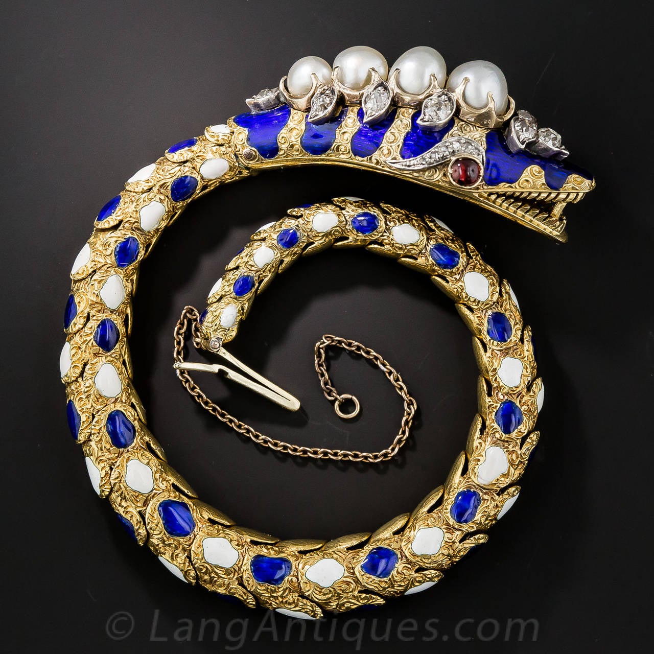 Here is a splendid example of an original nineteenth century snake bracelet on which countless copies were based during the 1960s. The lithe and supple scaled bracelet is hand crafted in richly textured, hand engraved 18K yellow gold and is