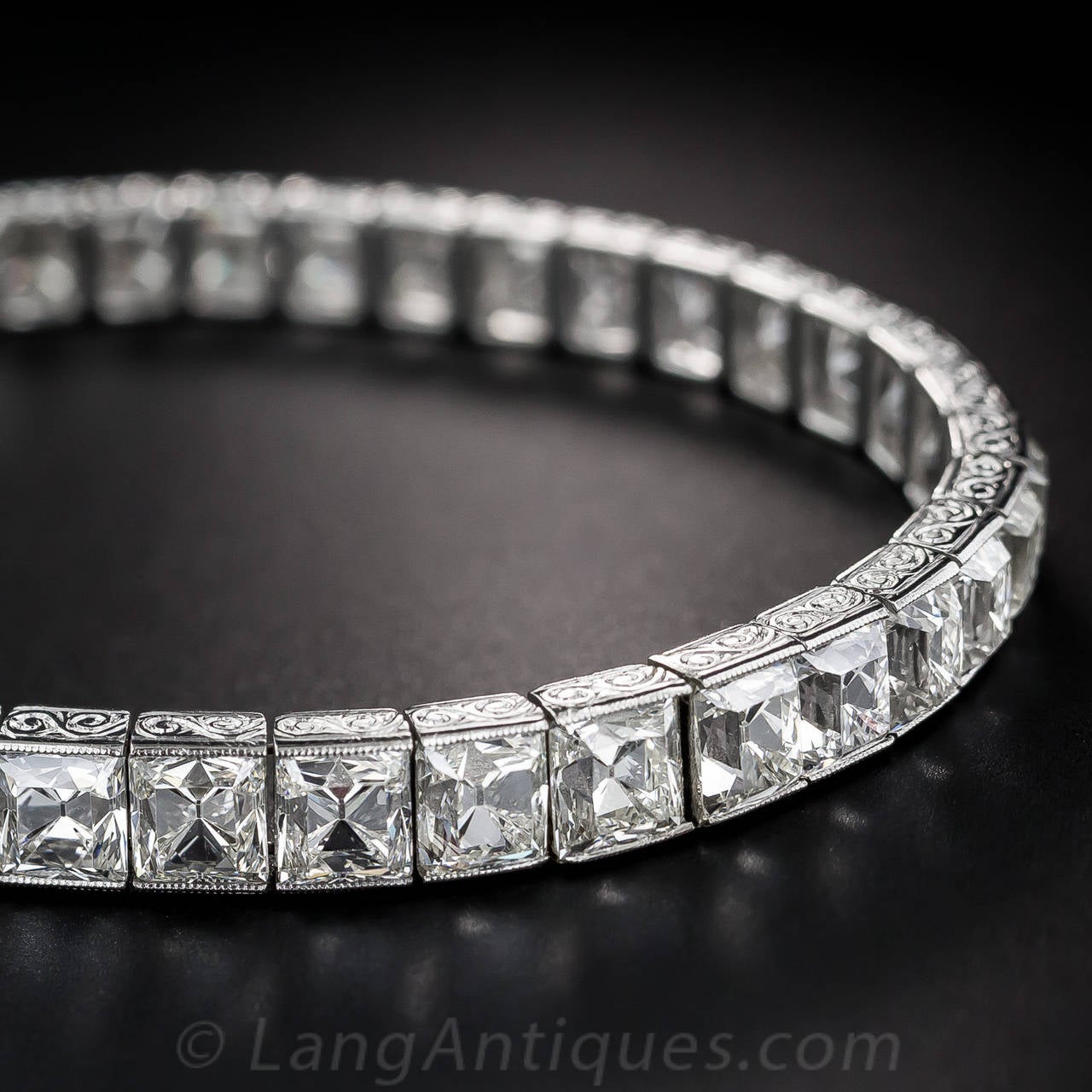 Simply stated, the most stunning and singularly sensational, Art Deco straight line diamond bracelet we've ever seen. 23 (at least) carats of bright-white, ultra-sparkling rectangular and square-cut diamonds with rare, highly-distinctive and hard to