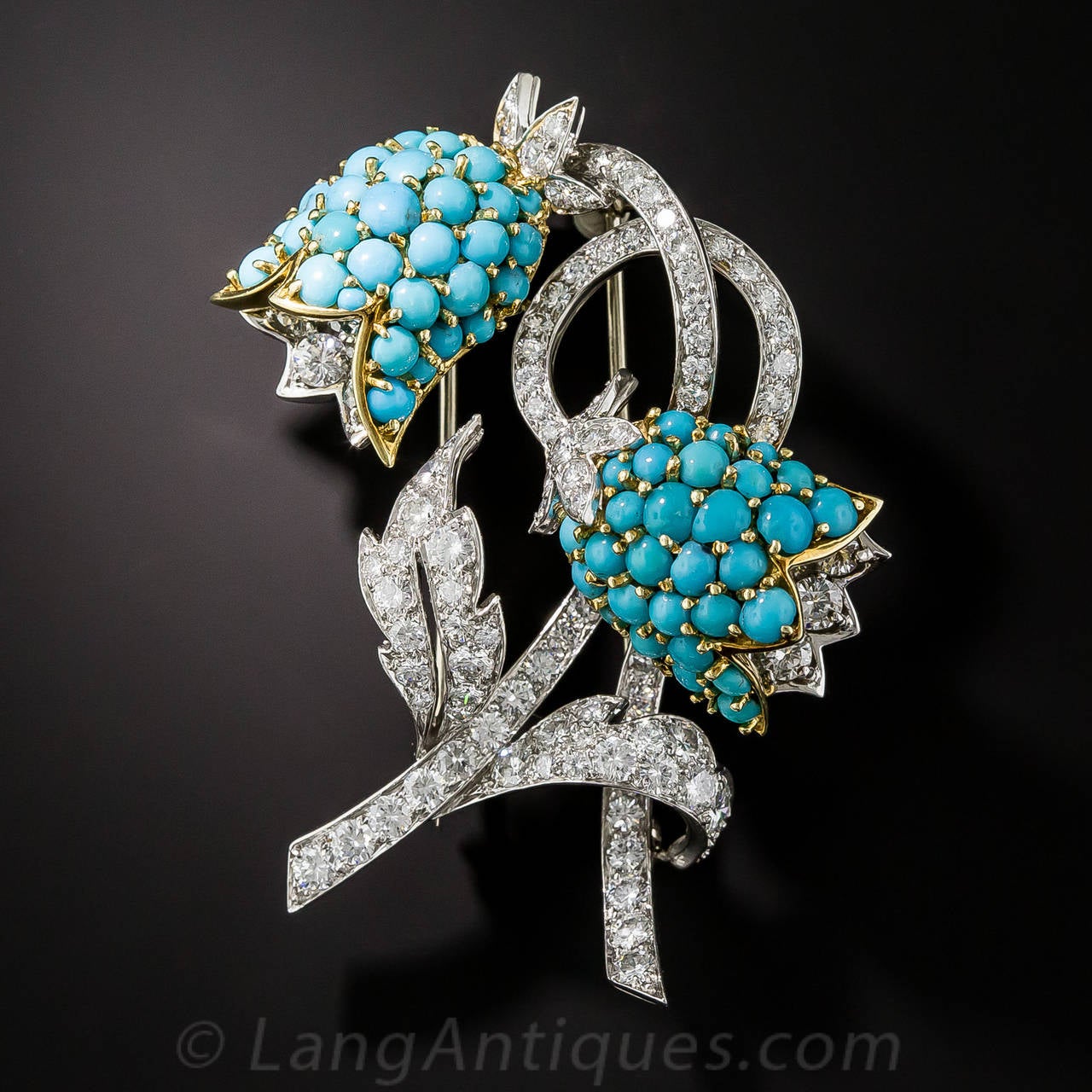 Ring in springtime all year round with this double charming bluebell brooch, artfully and masterfully hand crafted in platinum with a touch of 18K yellow gold. The multidimensional flowers are studded in bright turquoise and the sinuous stems and
