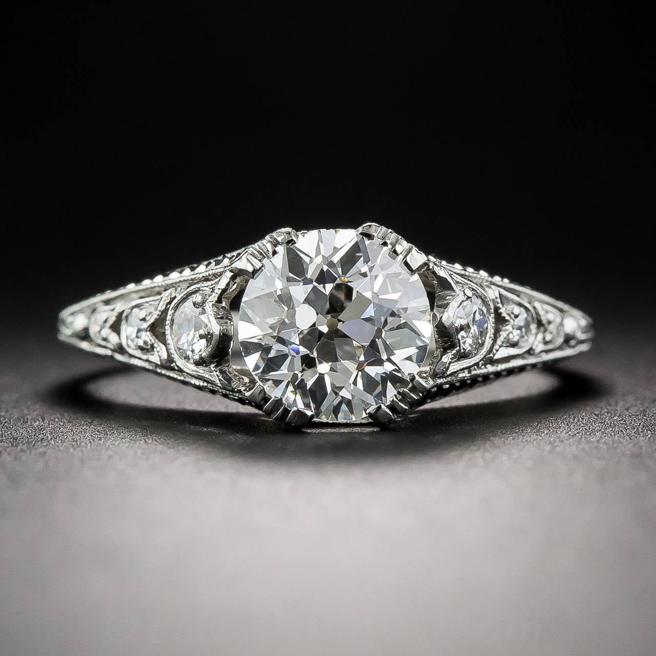A bright-white European-cut diamond, weighing 1.23 carats (accompanied with a GIA report stating G color VS1 clarity), with exceptional dispersion and brilliance, stars in this splendid, highly distinctive, original Art Deco ring. The mounting,