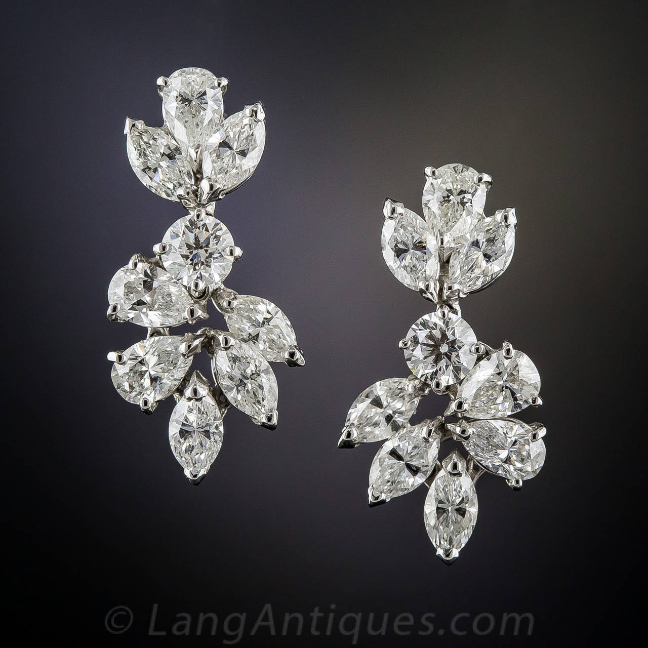 A harmonious medley of bright white and beautiful marquise and pear shape diamonds, divided by one round brilliant-cut diamond, swing and sway and throw off sparks in all directions in these classic Harry Winston style drop earrings - circa