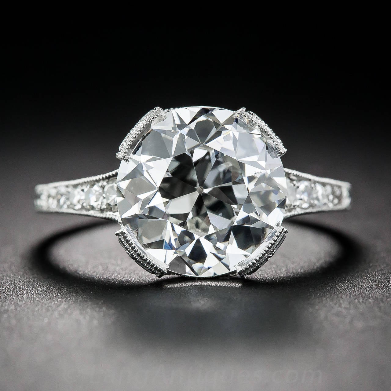 A glorious and glistening European-cut diamond, weighing just five points shy of 4 carats, sparkles mightily from within an elegantly restrained platinum and and diamond setting, newly and expertly hand-fabricated in enduring early-twentieth century