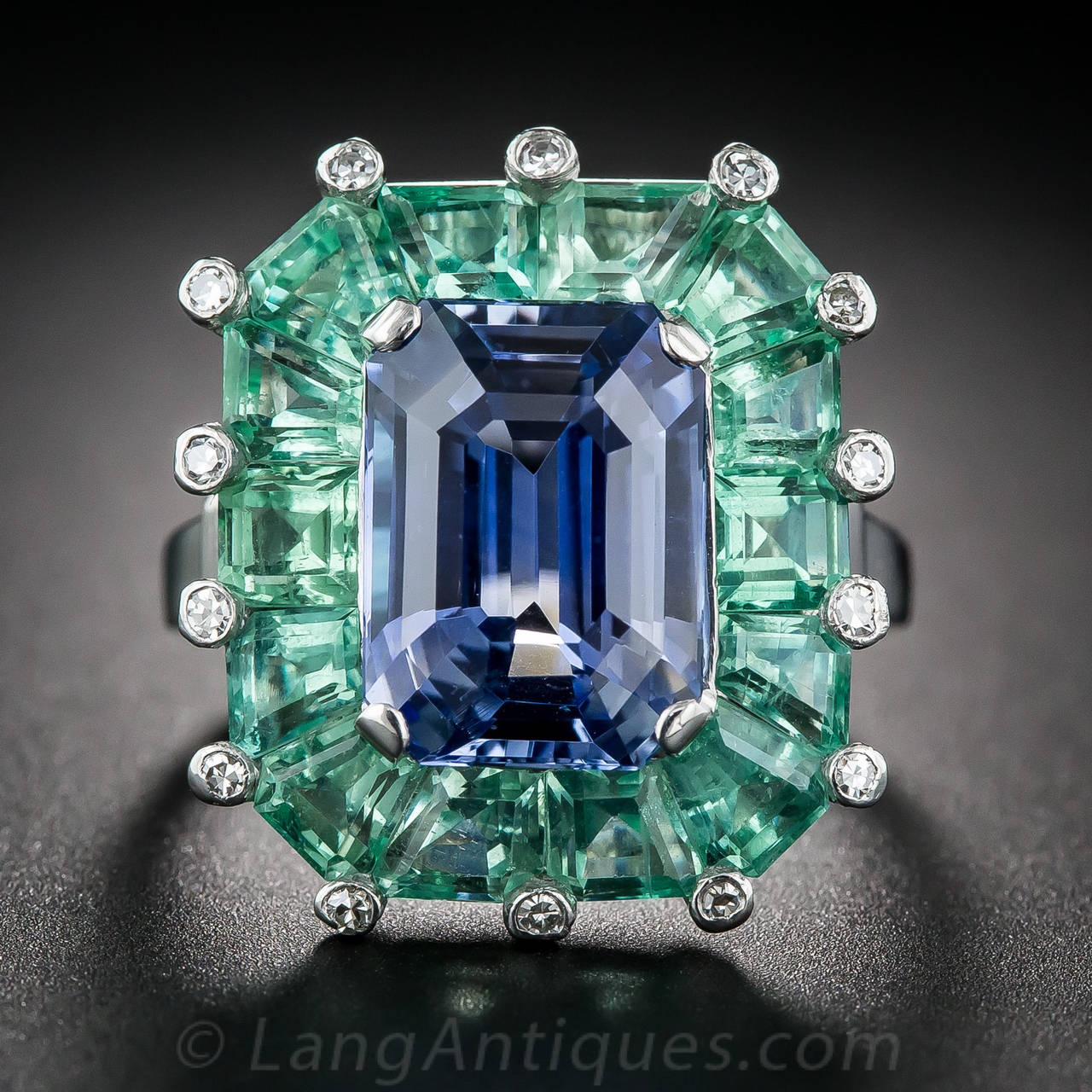 Unique, chic and magnifique! This intriguingly gorgeous vintage jewel, hand fabricated in platinum, circa 1930s-40s, highlights a sumptuous Ceylon blue emerald-cut sapphire, weighing 5.68 carats, bearing an AGL gemstone report stating: No