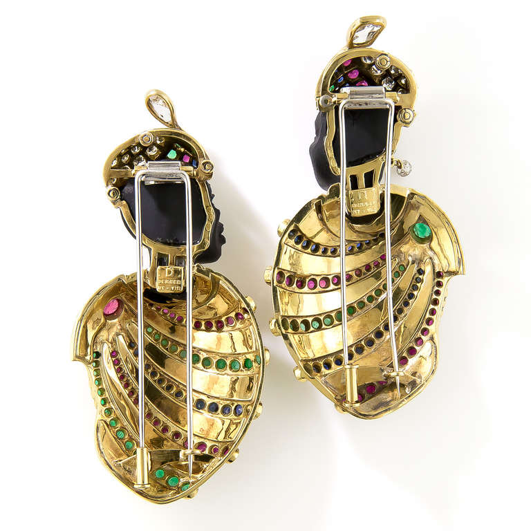 A distinguished couple - perhaps the king and queen of an exotic medieval North African kingdom - with their noble visages masterfully handcarved in onyx, are attired in full royal regalia strikingly and stunningly rendered in diamonds, rubies,