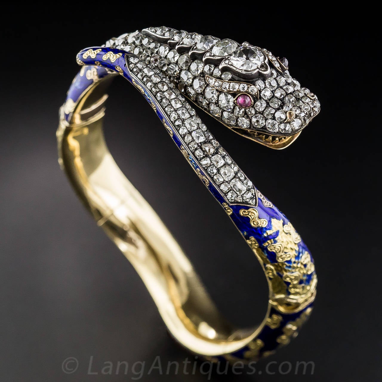 Striking barely begins to describe this exemplary early-Victorian snake bracelet - circa 1840 - magnificently handcrafted in silver over rich 18K yellow gold and packed to the hilt with over 12 carats of bright-white old mine-cut diamond sparklers,