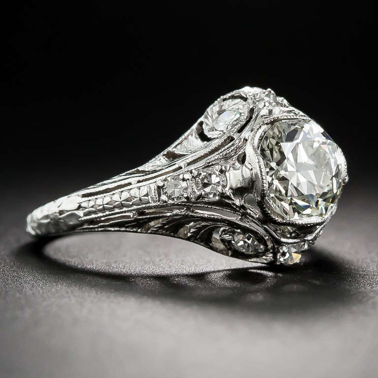 superbly and artistically sculpted platinum and diamond mounting distinguishes this original Art Deco sparkler - circa 1920s-30s. However, the crowning glory of this exquisite jewel is a bright and brilliant European-cut diamond, weighing 1.29