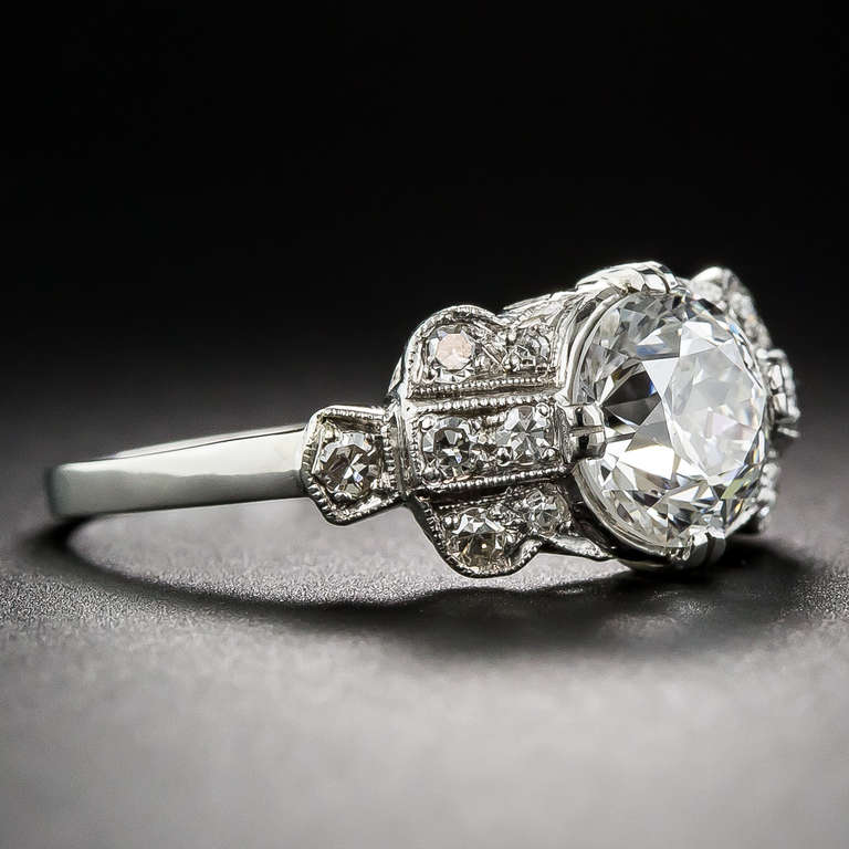 This ultra-sparkling, original Art Deco engagement ring, handcrafted in platinum during the 1930s, seriously scintillates with a bright icy-white 1.56 carat European-cut diamond, accompanied by a GIA Diamond Grading Certificate stating: G color -