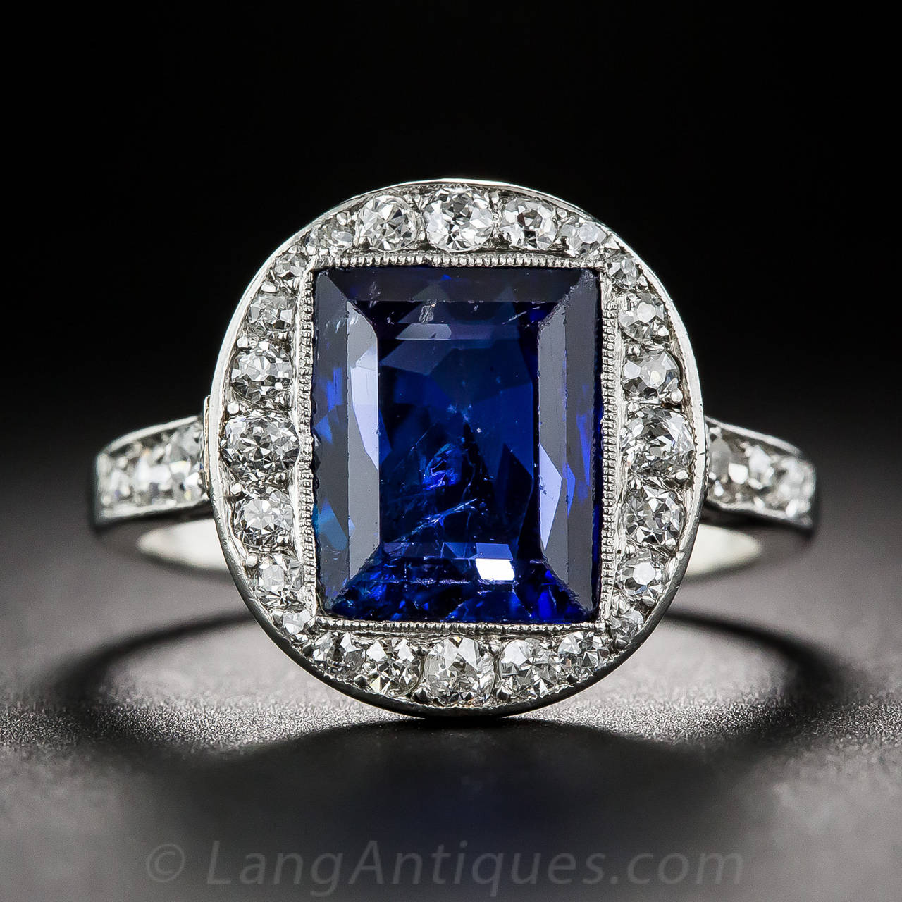 From the apex of the Art Deco period - circa 1925 - via Paris, France, comes this exquisite platinum and diamond jewel featuring a rich and ravishing, royal-blue, natural emerald-cut sapphire originating from the long ago exhausted mines of old