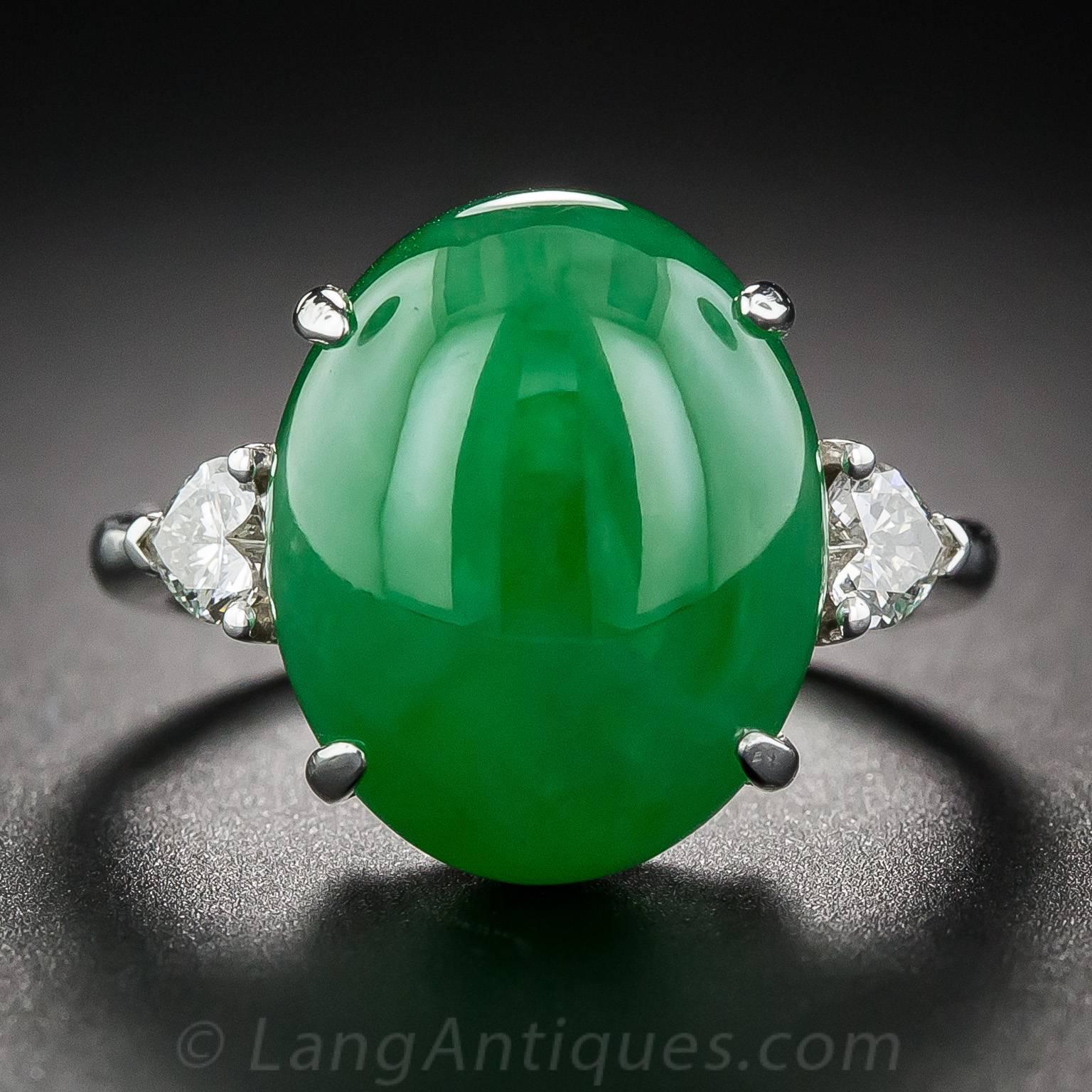 A luscious, rich, bright deep apple-green, translucent natural jadeite gumdrop glows from between a pair of sparkling heart shape diamonds in this colorful classic, crafted in bright 18K white gold. 

The jade is accompanied by a gemological