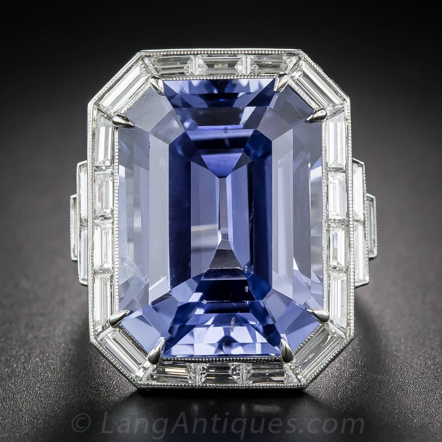 A breathtaking, bright blue emerald-cut sapphire, weighing in at 33.06 carats, radiates brilliantly from within a platinum frame of custom-cut baguette diamonds in this singular, sensational and sizable showstopper. The gorgeous gemstone is of