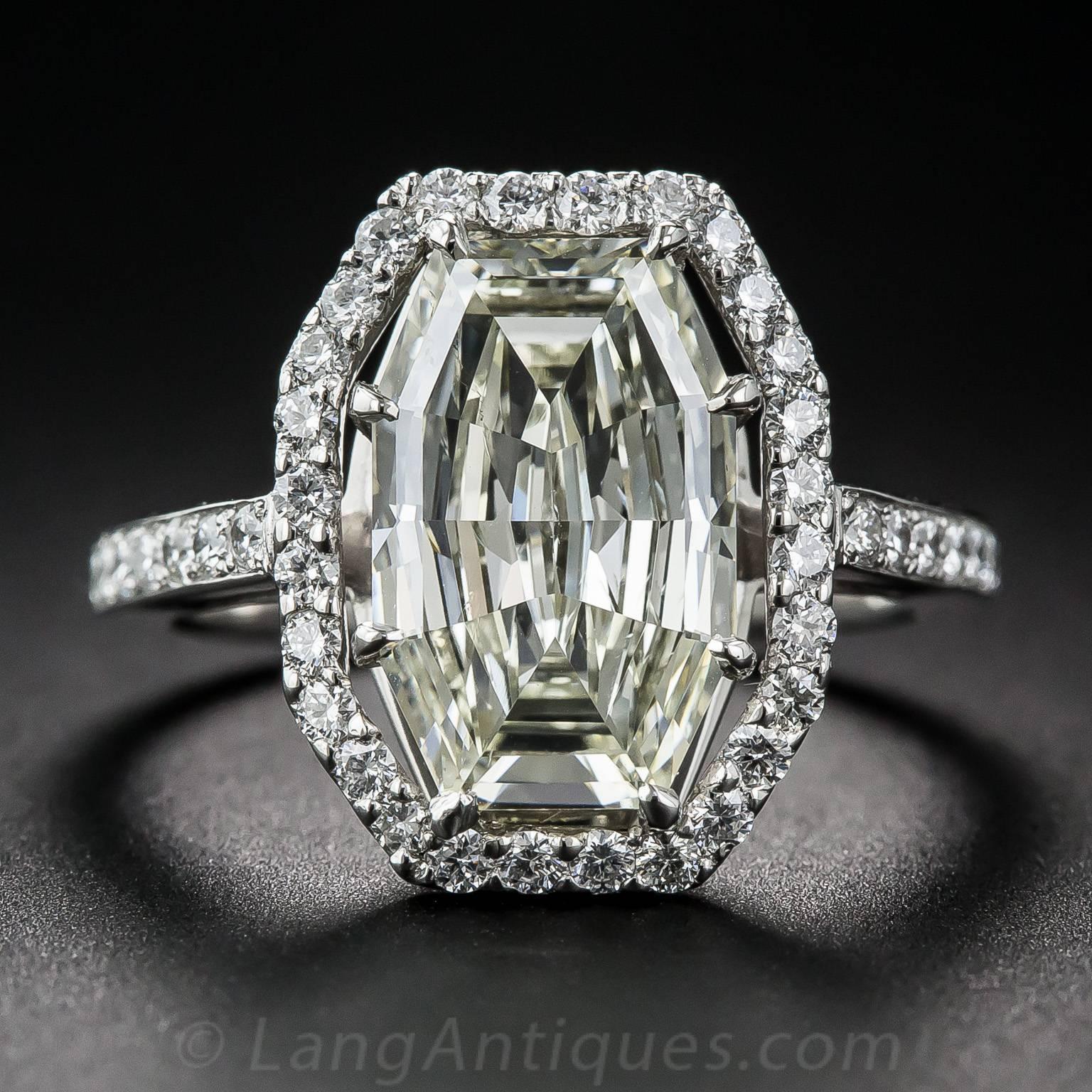 This unusual, if not unique, elongated octagonal shaped diamond, weighing 3.28 carats (but presenting significantly larger due to its masterful cut), reflects and returns light from every angle. This impressive ultra-sparkler is presented in
