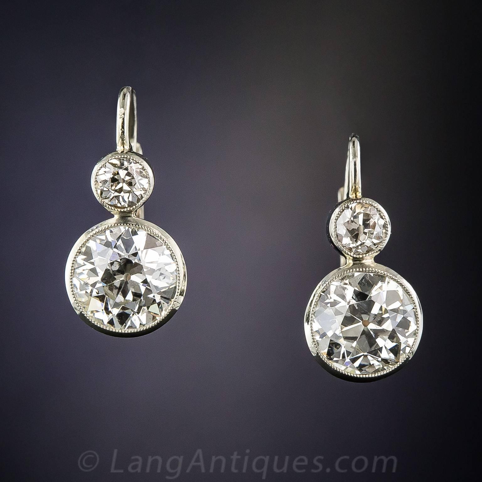 From 1920s Vienna come these bright and beautiful earrings featuring a dazzling pair of bright white European-cut diamonds, together weighing 3.20 carats. The diamonds are presented in delicately milgrained collet settings of 14K white gold which