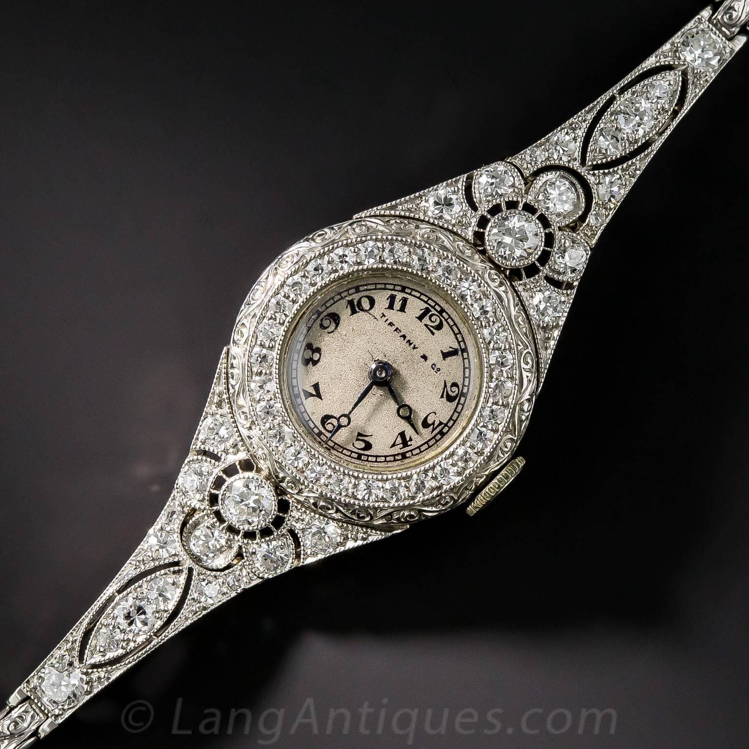 Exquisite in every way, an original early Art Deco bracelet watch by America's premier jeweler of the time (the 1920s) - Tiffany & Company. Expertly and artfully hand crafted in platinum, the round dial is double framed: inside with a sparkling